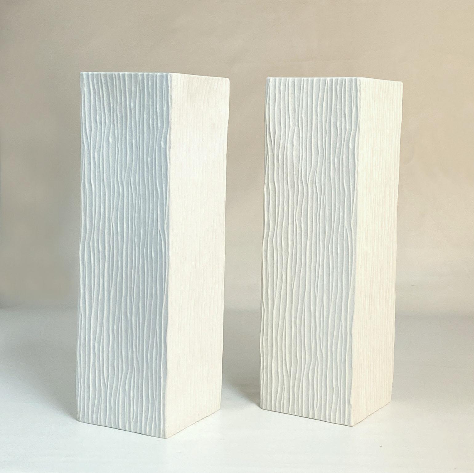 Pair of tall white porcelain square vases with vertical relief surface, by Hutschenreuther Germany, 1960's.

