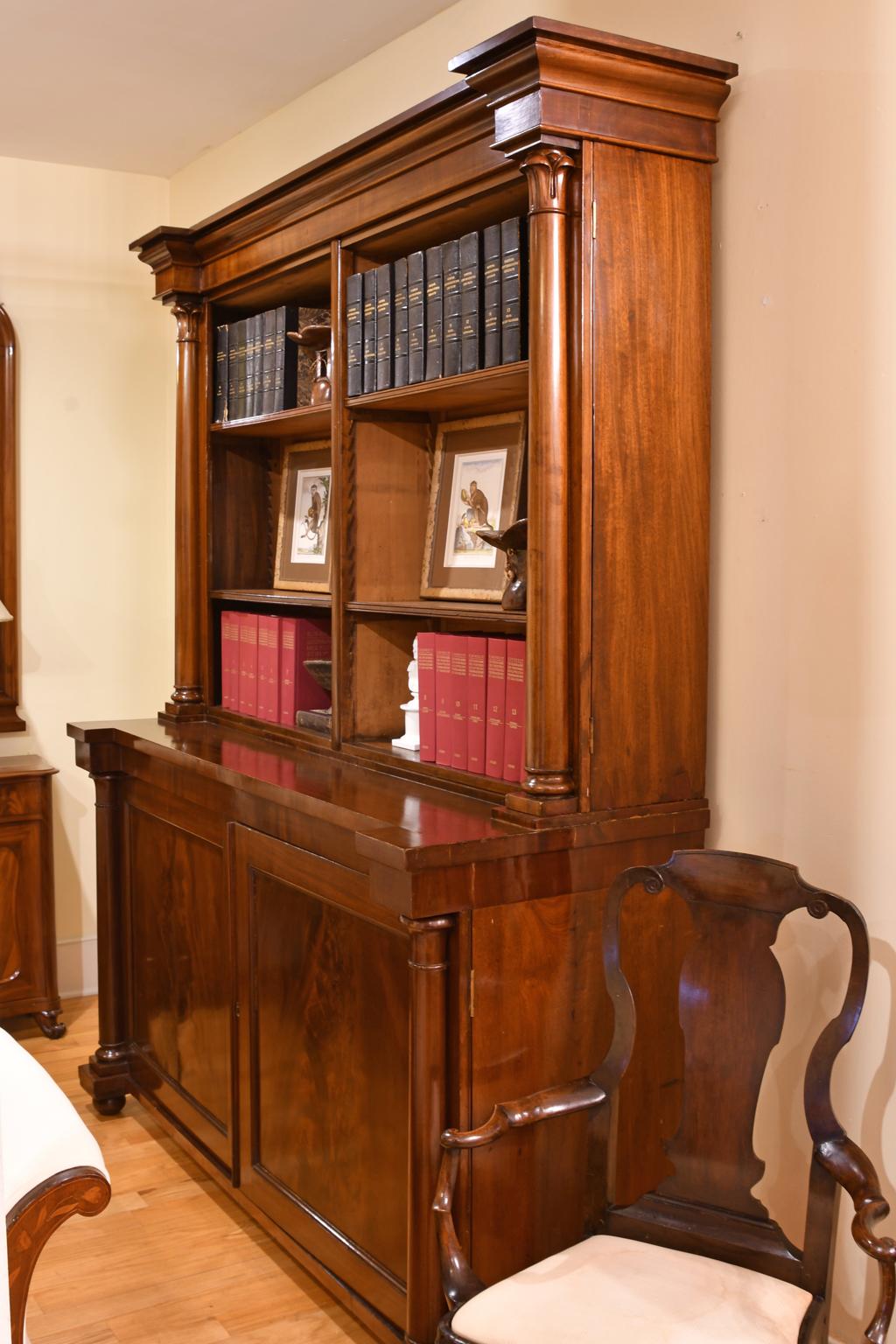 A pair of beautifully-crafted William IV breakfront bookcases in fine West Indies mahogany with open book storage on upper section and closed lower cabinets for storage. These period bookcases display an understated elegance and feature a fine play