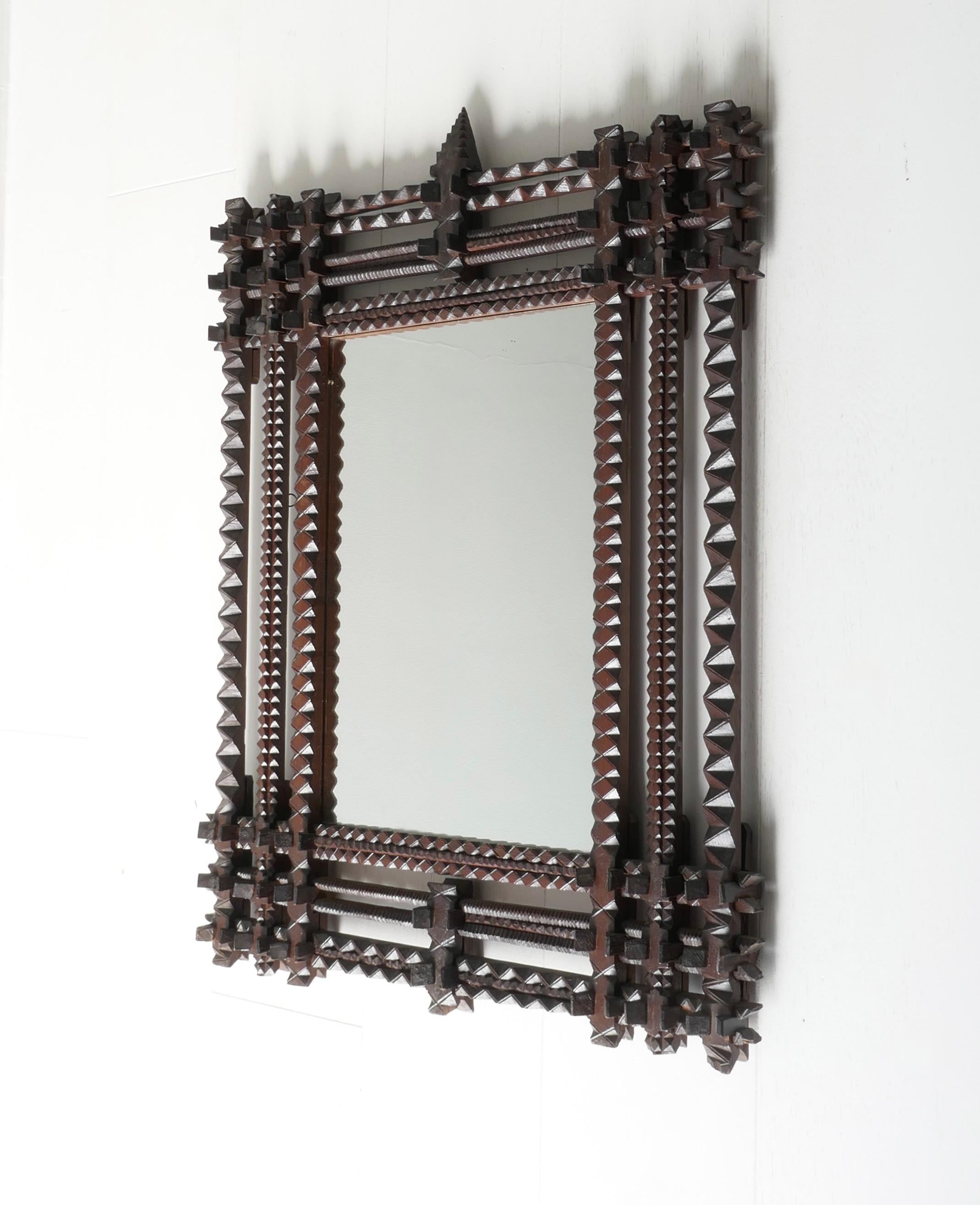It is very rare to find a pair of these frames of this large size, quality and complexity. The pieces have been hand carved and assembled like a 3-dimensional puzzle. The pitch pine frames with dark patina date from circa 1880. They were originally
