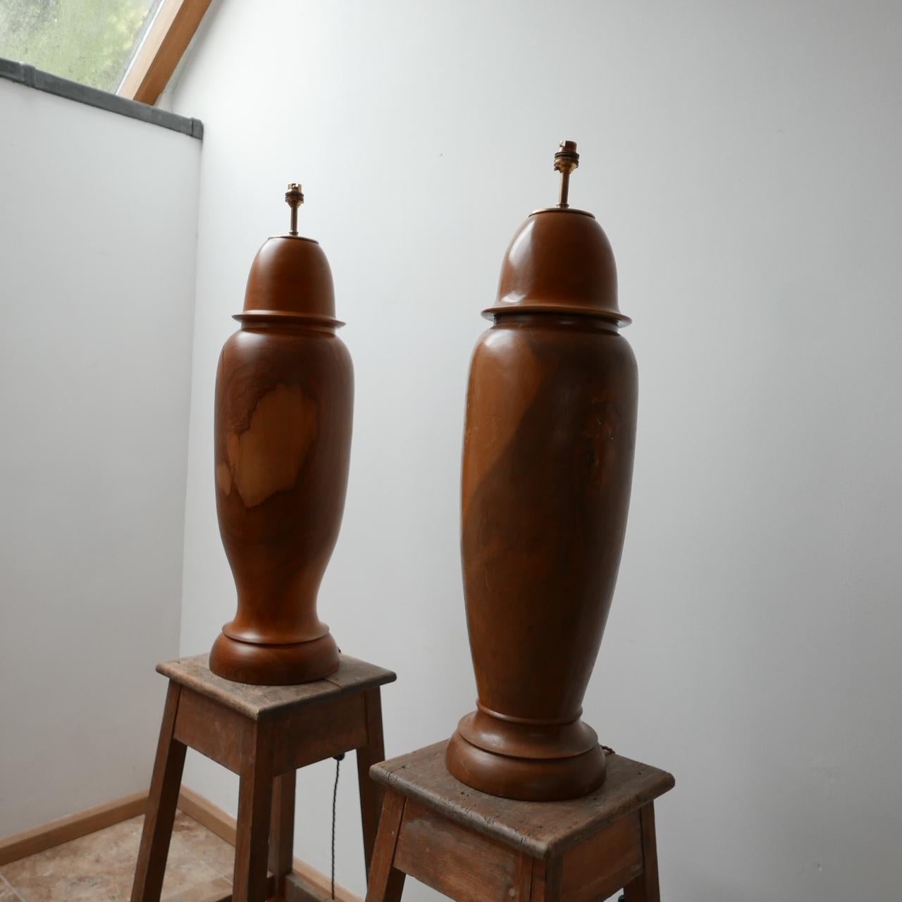 A pair of very large table lamps,

c1950s, England.

Originally the caps came off, although we were unsure of original use but they have been professional converted into table lamps. 

Re-wired with gold silk flex. 

These would sit well in