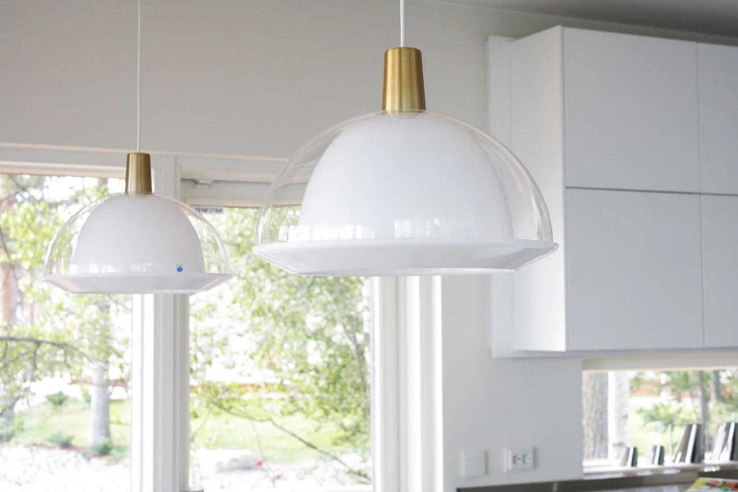 Pair of Large Yki Nummi Transparent 'Kuplat' Pendants. Designed in 1959, Nummi's iconic light consists of two acrylic shades of different colors, one nesting inside the other. The name Kuplat means bubbles in Finnish. As Nummi once astutely