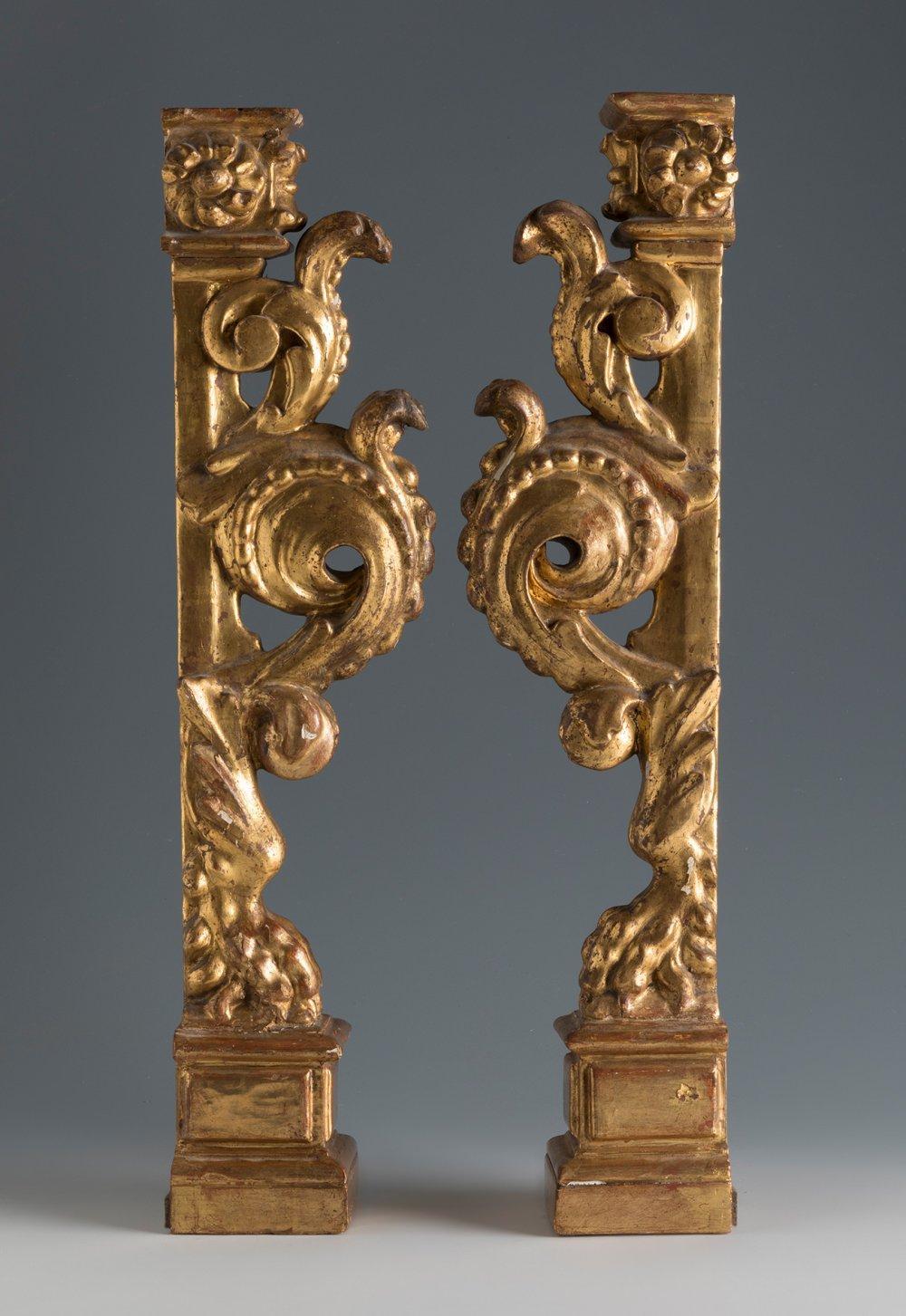 The present pair of late 17th century or early 18th century Spanish Baroque giltwood architectural elements may have once formed part of an altarpiece environment. Their decorative program features lion’s feet set upon Classically inspired plinths