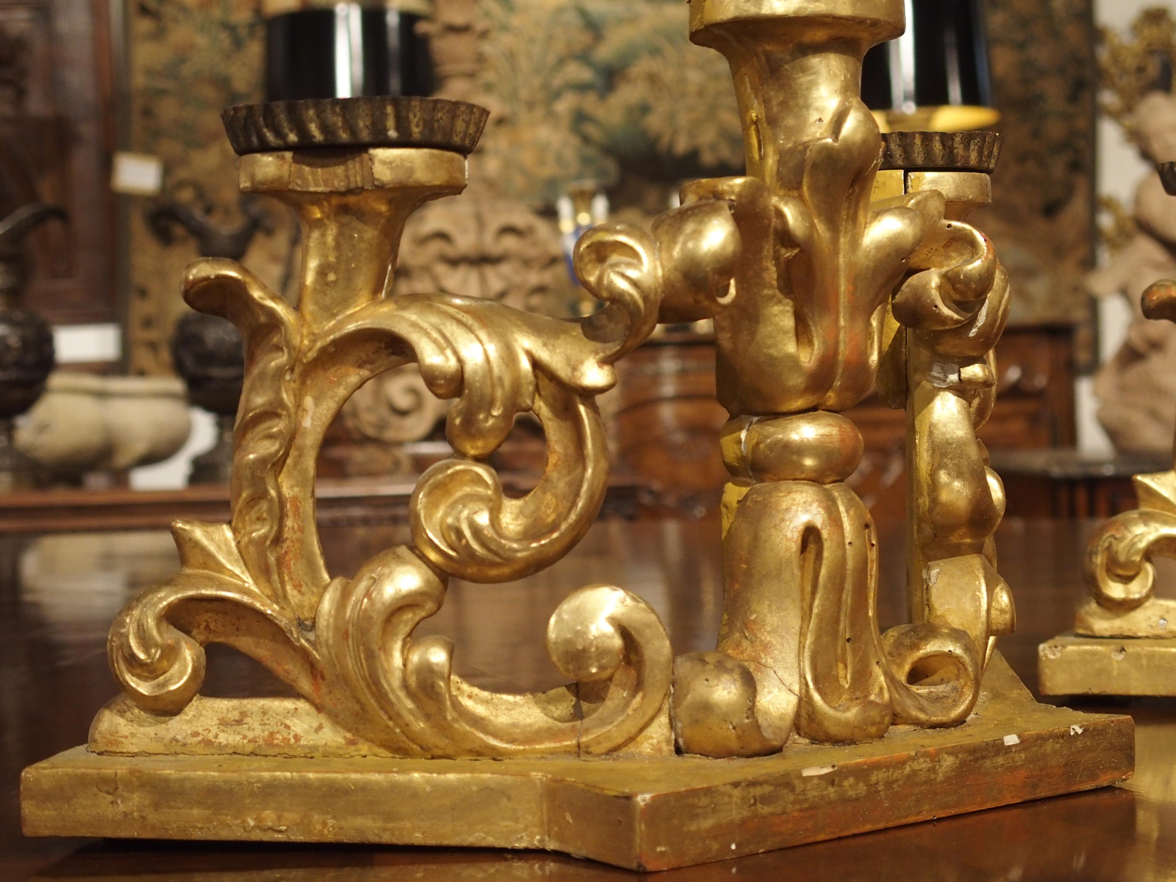 Gold Leaf Pair of Late 17th Century Italian Giltwood Three-Light Candlesticks
