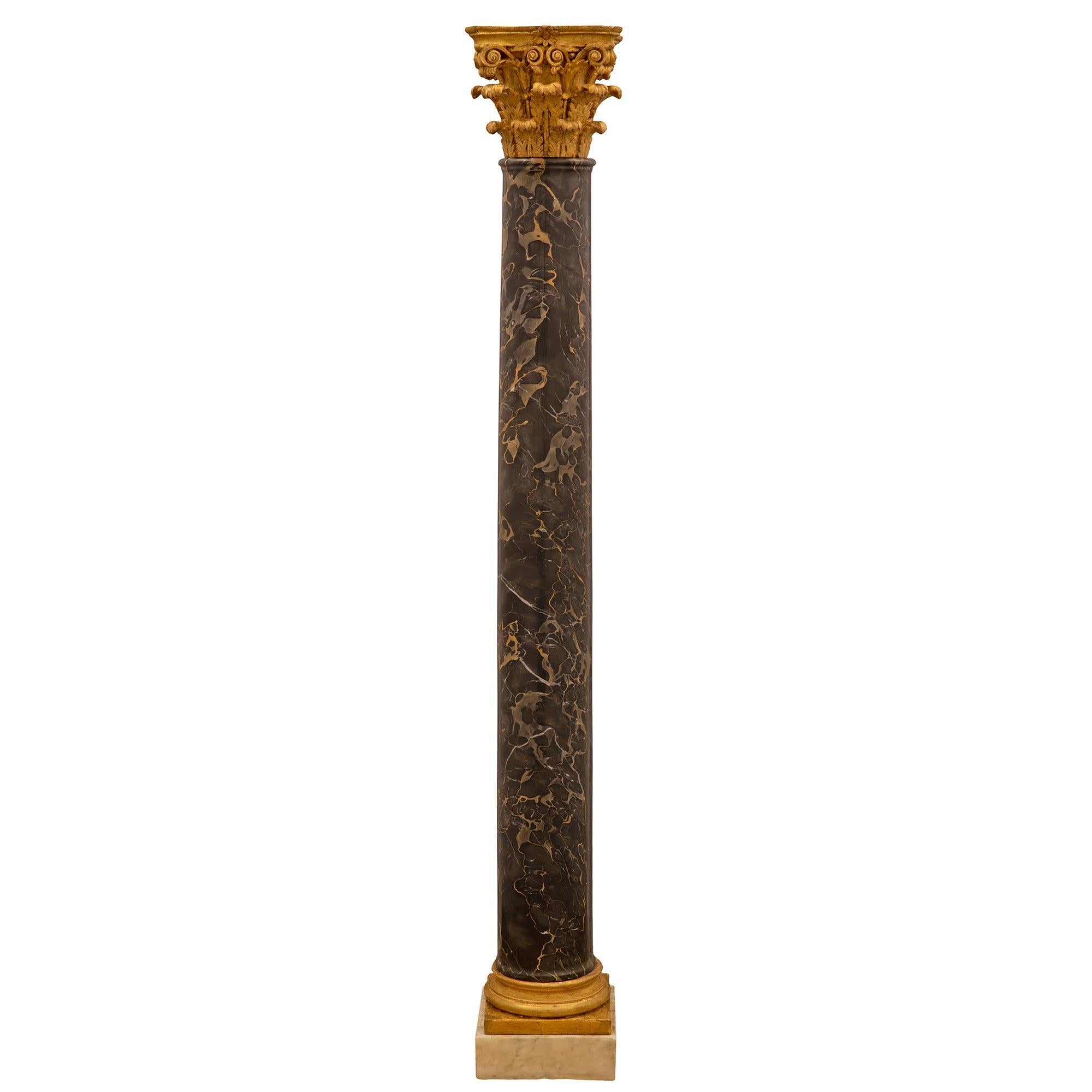 A striking and very high quality pair of Italian late 18th/early 19th century onyx, giltwood and portoro marble columns. Each column is raised by a square onyx base below an elegant mottled square and circular giltwood reserve. The impressive solid
