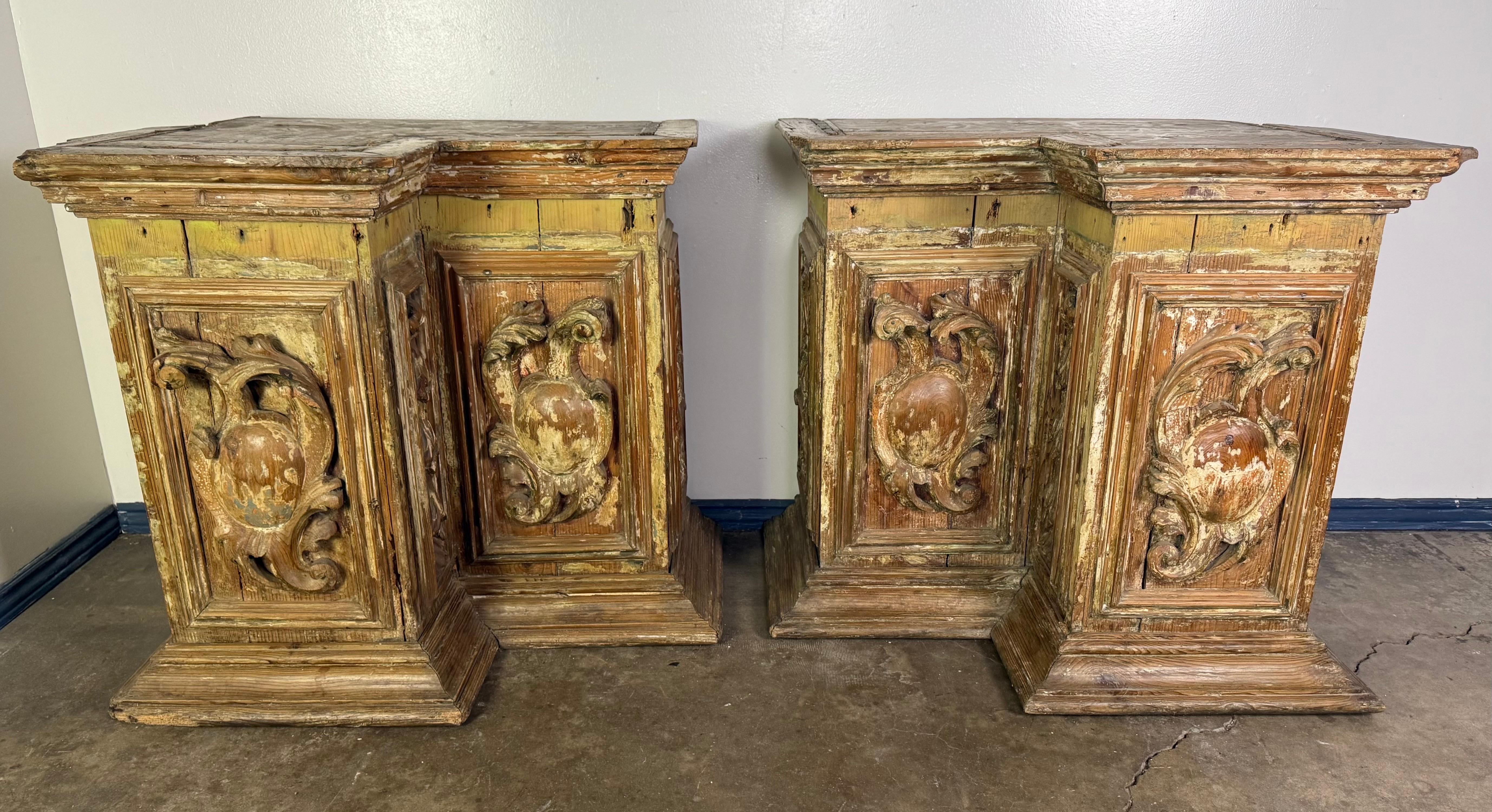 A remarkable pair of late 18th century Italian architectural elements, likely salvaged from a chapel or palazzo interior. Each piece is hand-carved from wood, showcasing deeply modeled foliate scrolls and shield motifs framed within recessed panels.