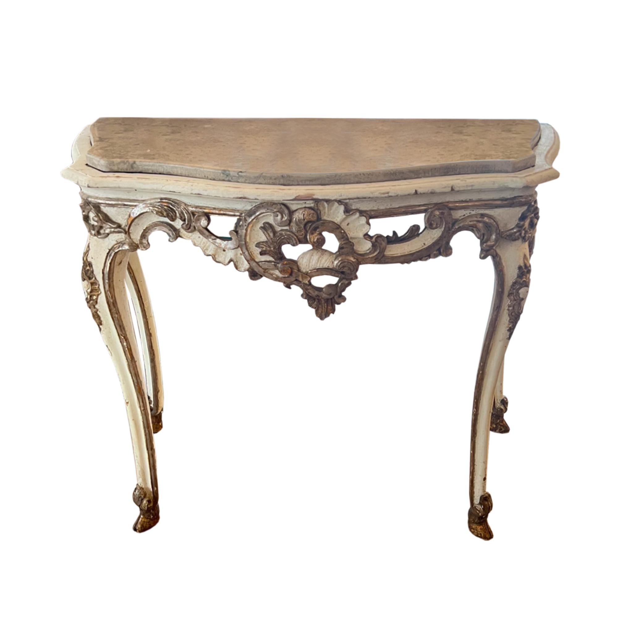 A spectacular pair of rococco console tables - they were made in Italy in the late 18th century. 

Please take a look at all our photographs to see the detailed carving and later marble tops.

Giltwood with silver leaf and white paint. 

Finished