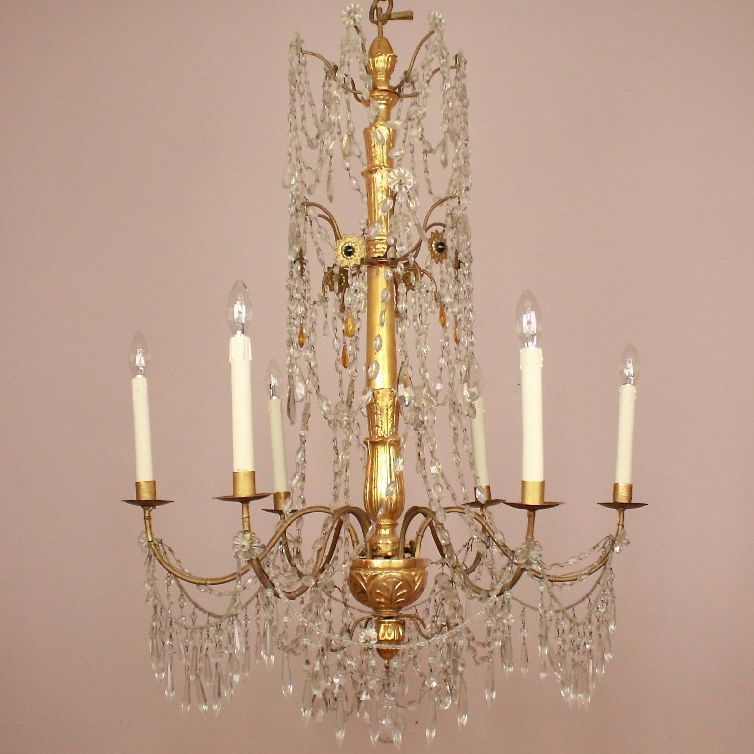 Pair of Late 18th Century Neoclassical Genoa/Italy Giltwood Crystal Chandeliers

A pair of large late 18th century giltwood, giltmetal cut crystal and coloured glass chandeliers from Genoa. Each with a foliate-wrapped slender baluster-shaped