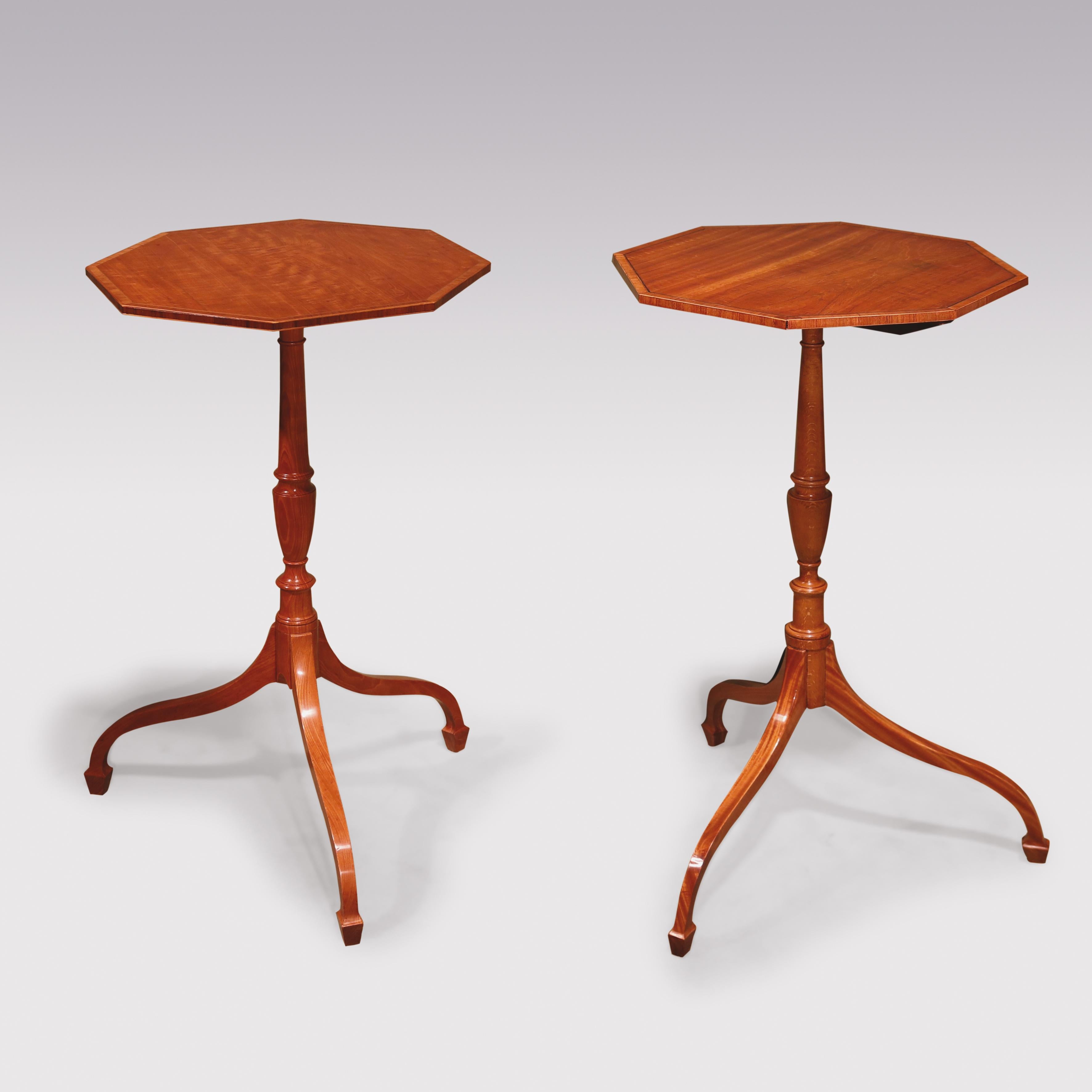 A matched pair of late 18th Century Sheraton period satinwood Tripod Tables, having tulipwood crossbanded octagonal tops, raised on slender vase-turned stems, supported on umbrella shaped legs, ending on spade toes.