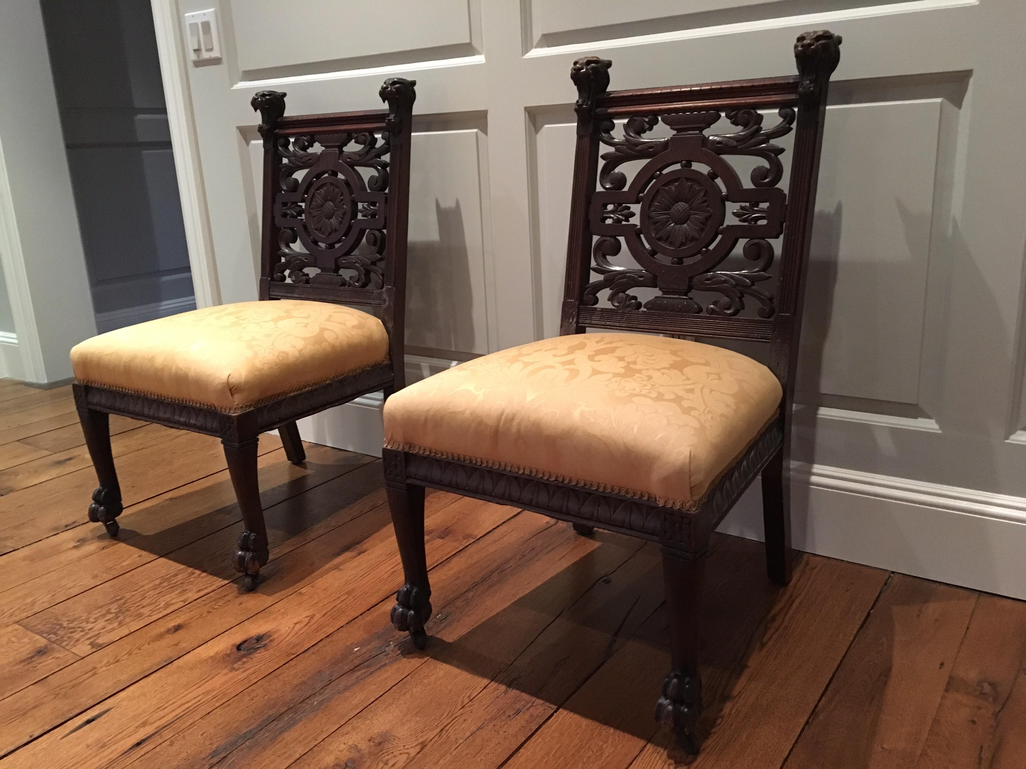 Pair of Late 19th century side chairs, aesthetic movement, circa 1890. Ornate, heavily carved backs central floral carving with tiger head and paw carvings. On casters. Minor chip on the front rail. Good structurally condition. Minor scratches to