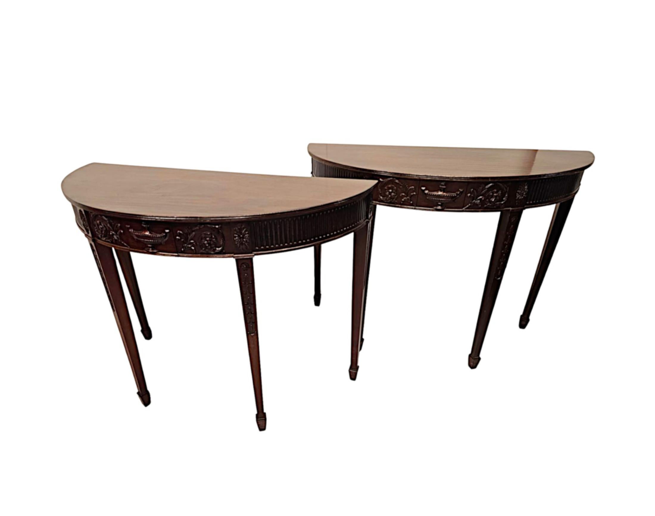 A very rare pair of 19th Century mahogany side or console tables in the manner of Adams, finely hand carved with beautifully rich patination and grain and of exceptional quality.  The well figured, moulded tops of demi-lune form with reeded border