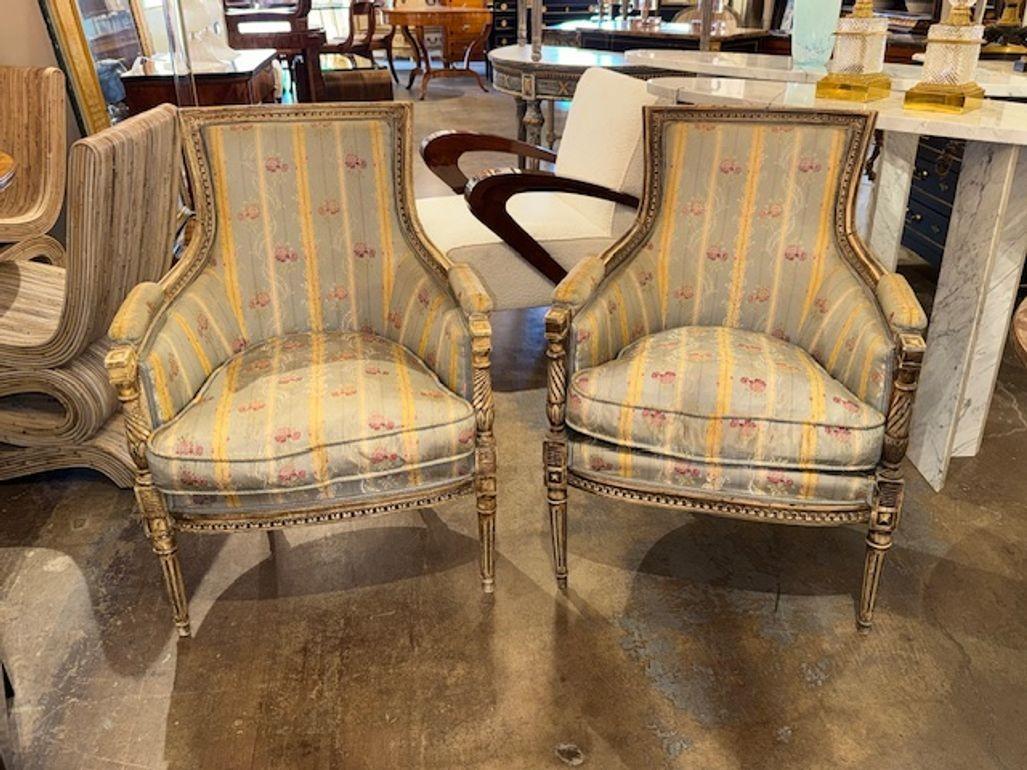 Pair of late 19th century French Louis XVI style carved and painted armchairs. Circa 1900. A fine addition to any home! 26W x 27D x 37H