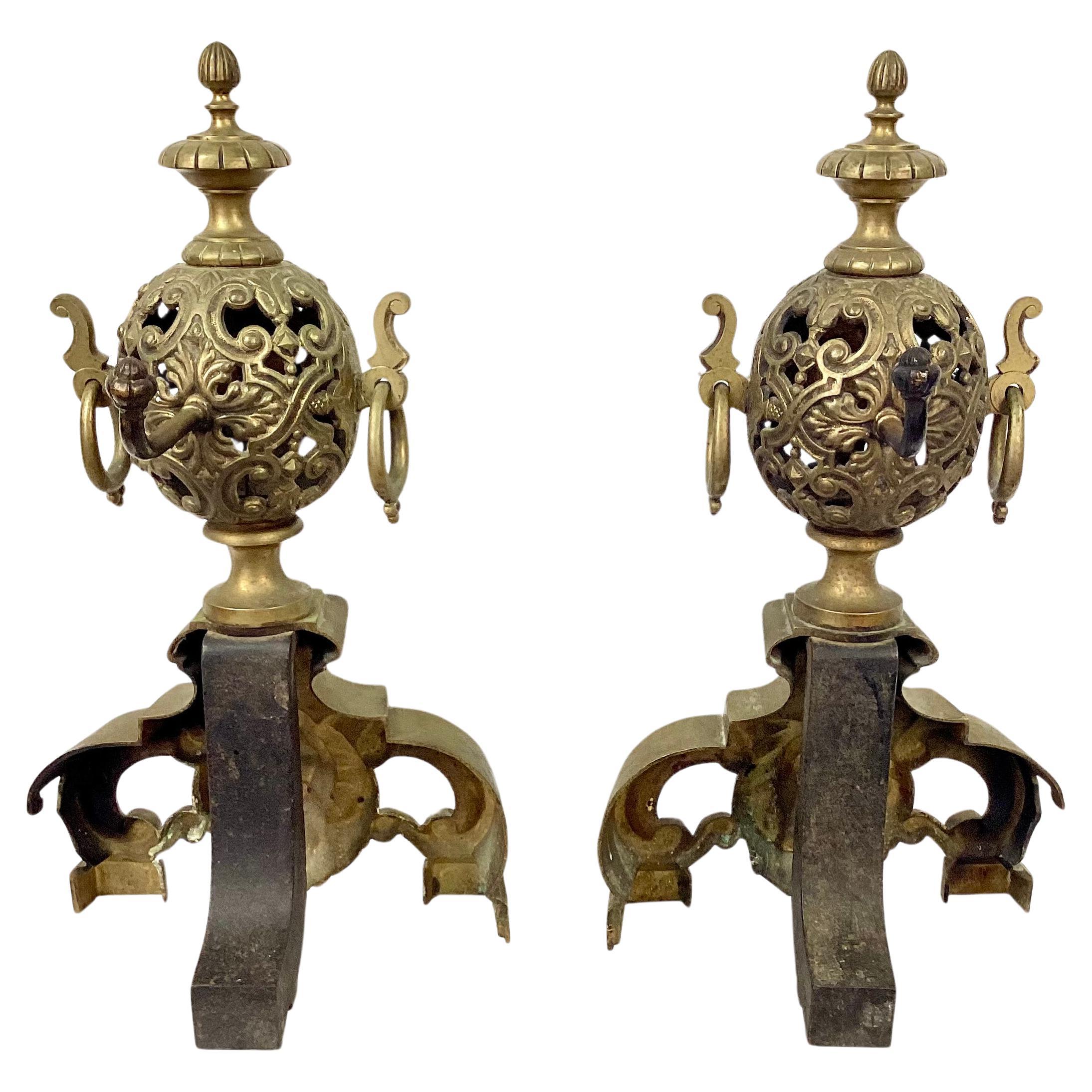 Great looking pair of late 19th century Lion's Head Andirons. Each features ornate designs on upper round shaped orbs and stunning brass lion's head crests in the bottom center.  Heavy brass has a wonderful old patina. 