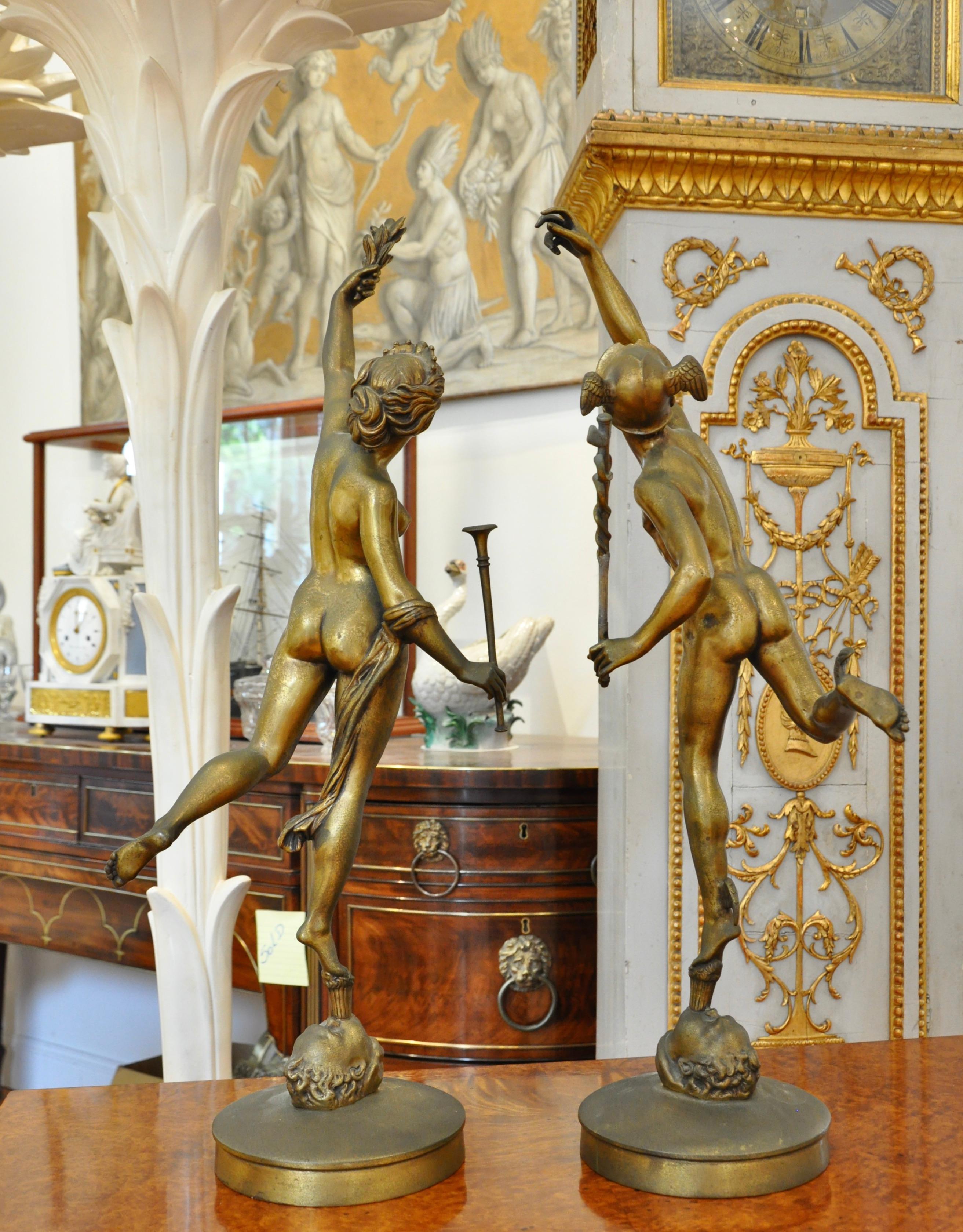Pair of 19th century bronze statues of the God Mercury and the Goddess Fama. In Greek Mythology, Hermes and Pheme. Both classically posed, Fama with a trumpet and laurel and Mercury with Caduceus. 

We left the pair in patina, though could be