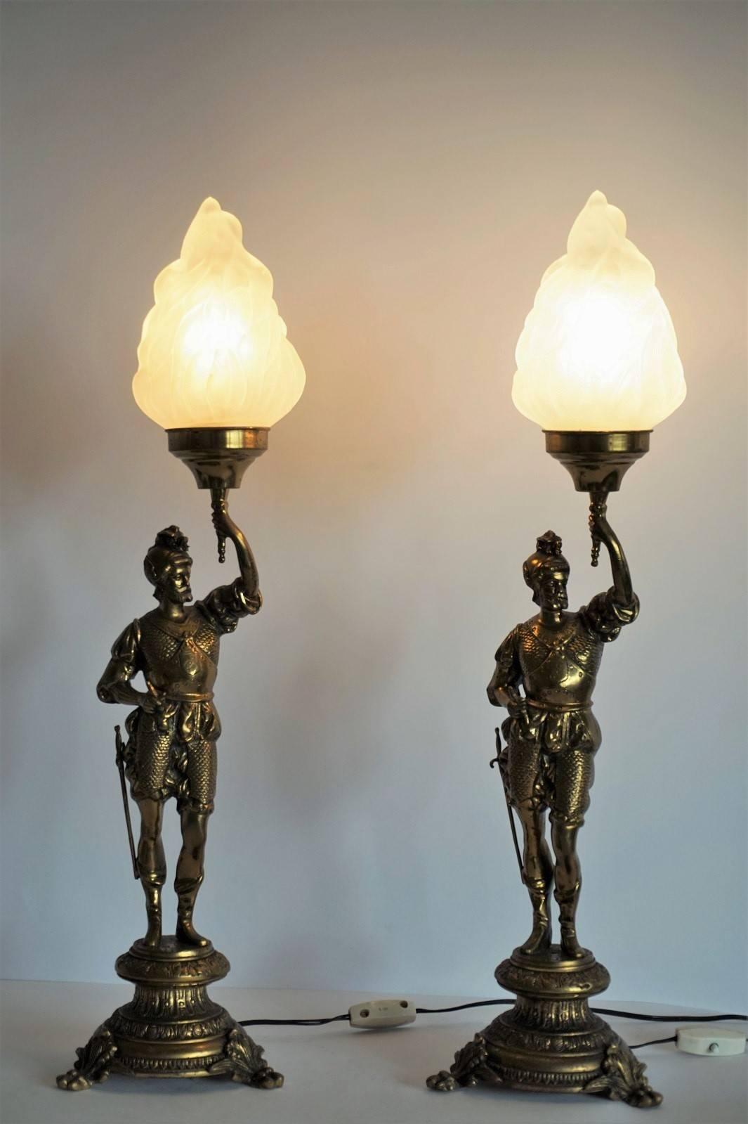 Pair of late 19th century solid bronze and brass soldiers candelabra later converted to table lamps, with large frosted glass shades.

Measures: Total height: 25 in (64 cm) 
height without lampshade: 18 in (46 cm)
Base diameter: 6 ¼ in (15.5