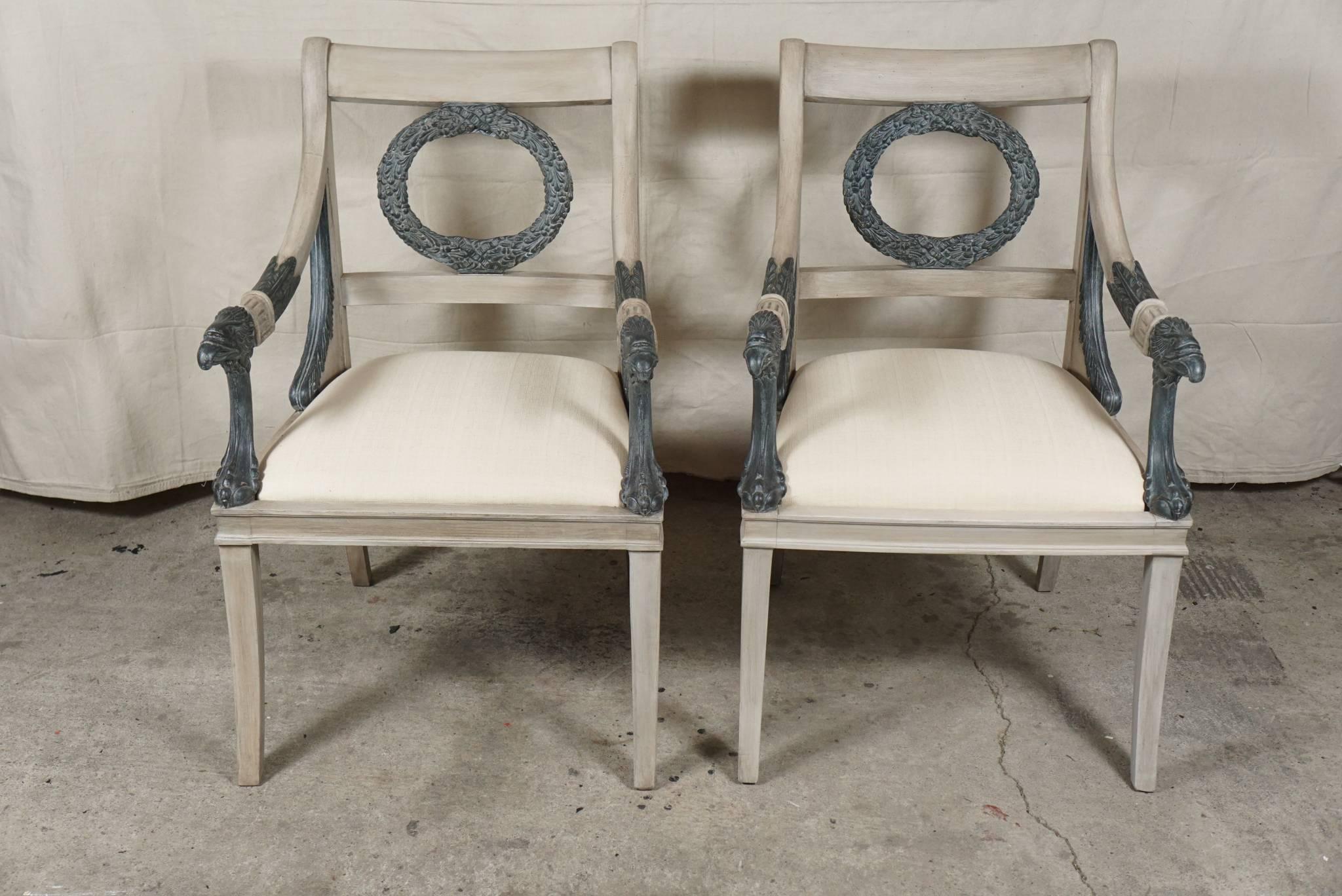 This pair of chairs Swedish or Scandinavian in manufacture were made circa 1880-1900. Of large-scale and finely carved they are in the Empire or Regency taste. Decorative elements include the saber legs, eagle head arms and claw foot upright