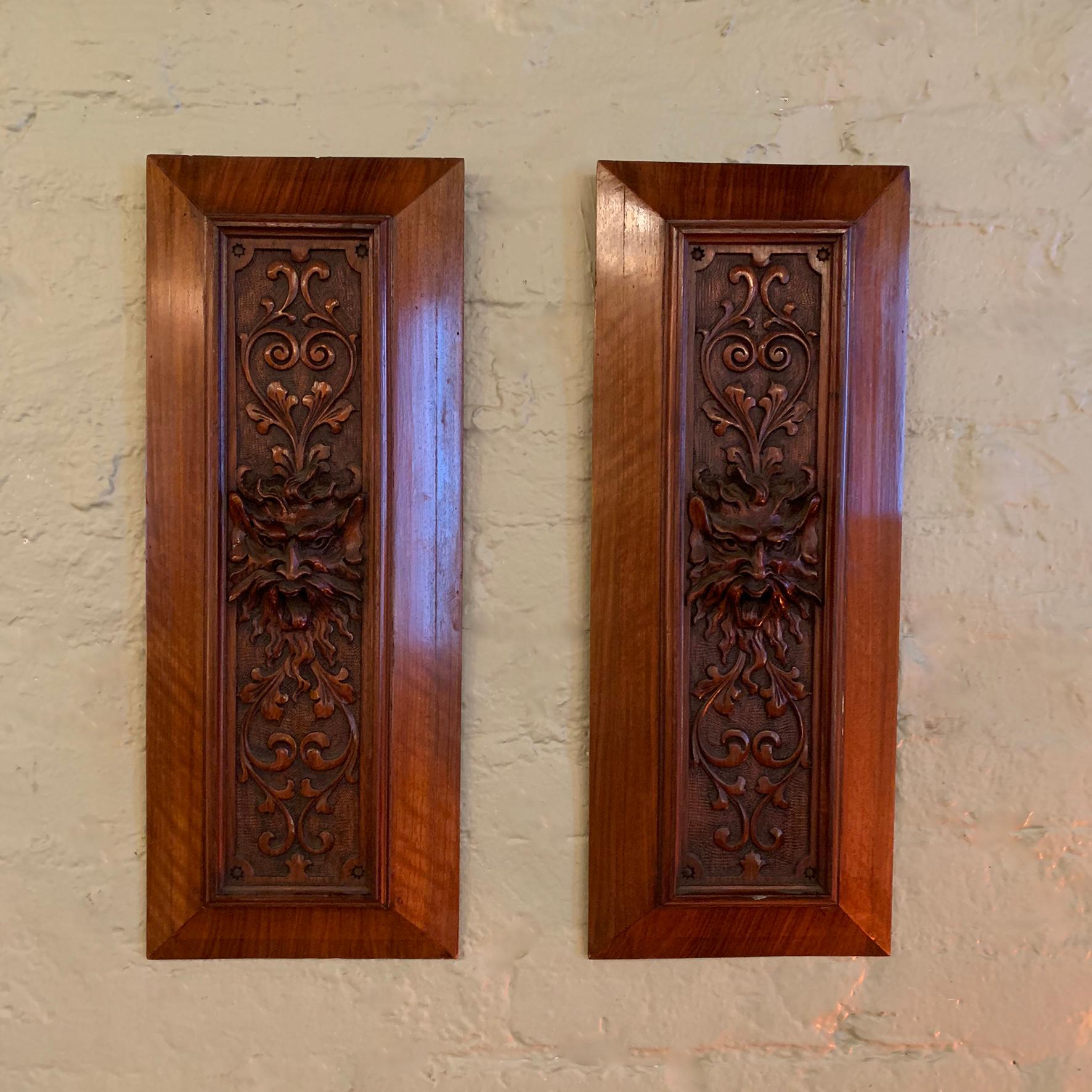 Pair of late 19th Century, relief carved, mahogany panels emanating from a gargoyle head.