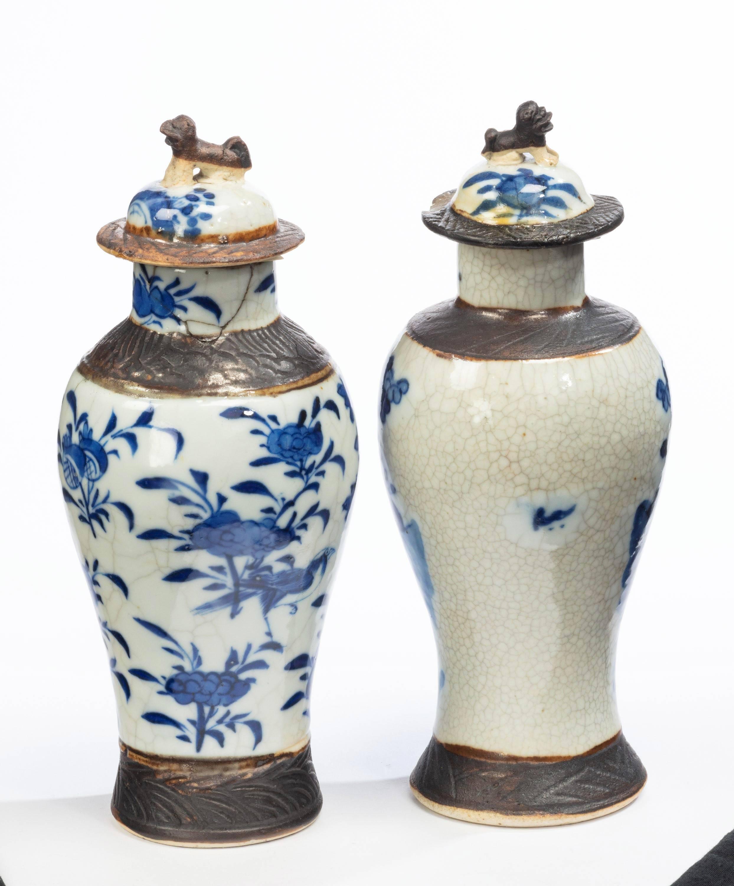 A pair of late 19th century Chinese crackleware vases of ovoid shape. Both vases with large enamelled figures. One lid has a chip to the edge with old damage to the top of the second.
  
