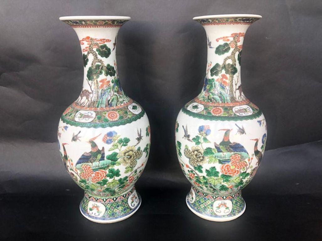 Pair of porcelain Famille Verte Chinese vases made in the Late 19th century. They depict botanical hand painted details and shapes, as well as beautiful animals surrounding the scene.
Dimensions:
18