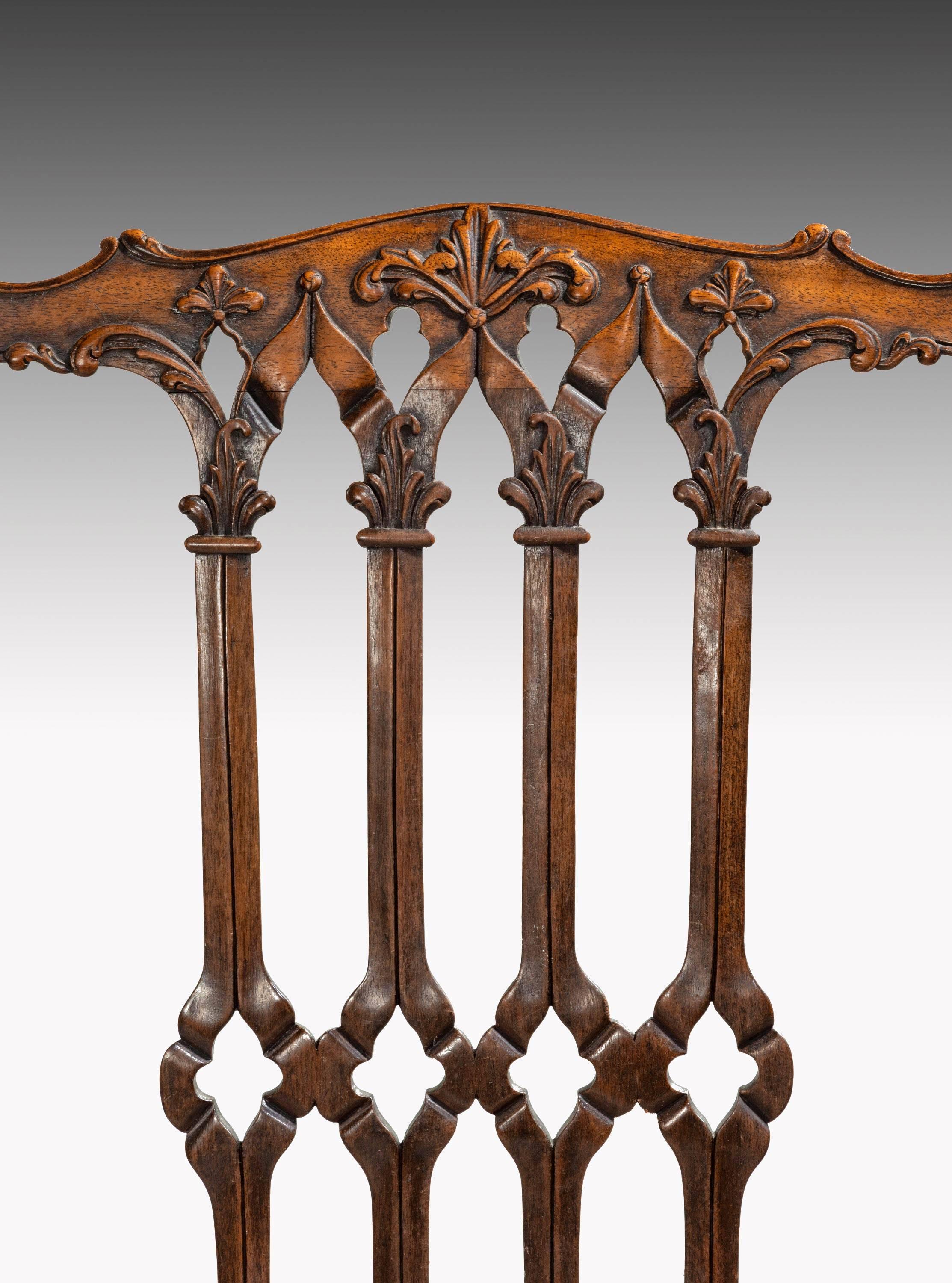 A handsome and well-carved pair of mahogany framed chairs of Chippendale design. With pierced back splats with elaborate detail. The top beautifully carved. On cabriole claw and ball supports.
T
 