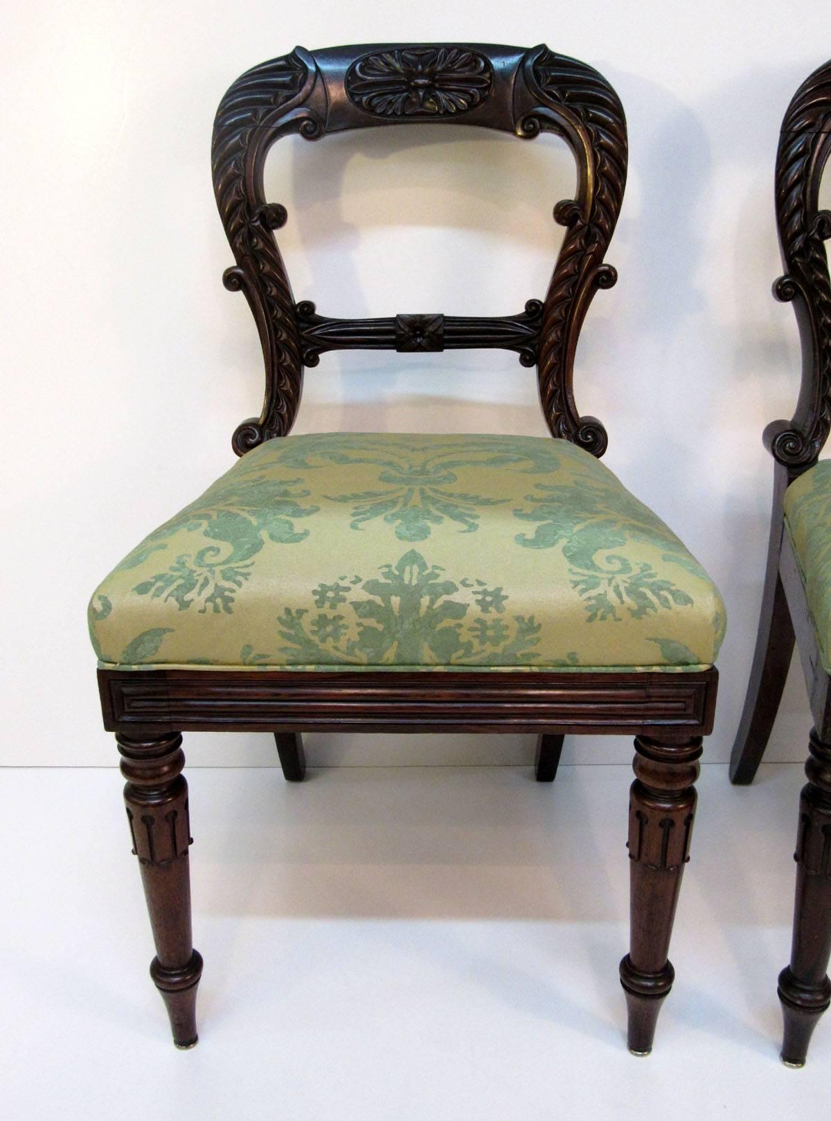Pair of late 19th century English Regency side chairs with upholstered seats.