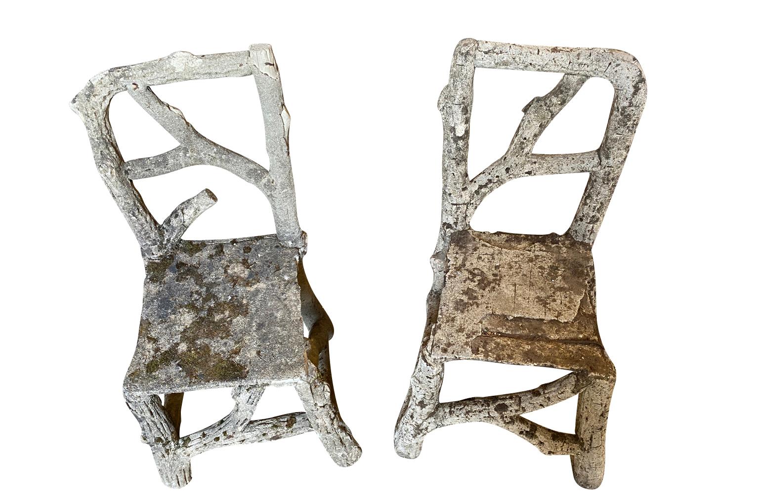 A wonderful pair of late 19th century Faux bois garden chairs - side chairs from the Provence region of France. Beautifully crafted from concrete. Fabulous patina. The seat height is 16 3/4