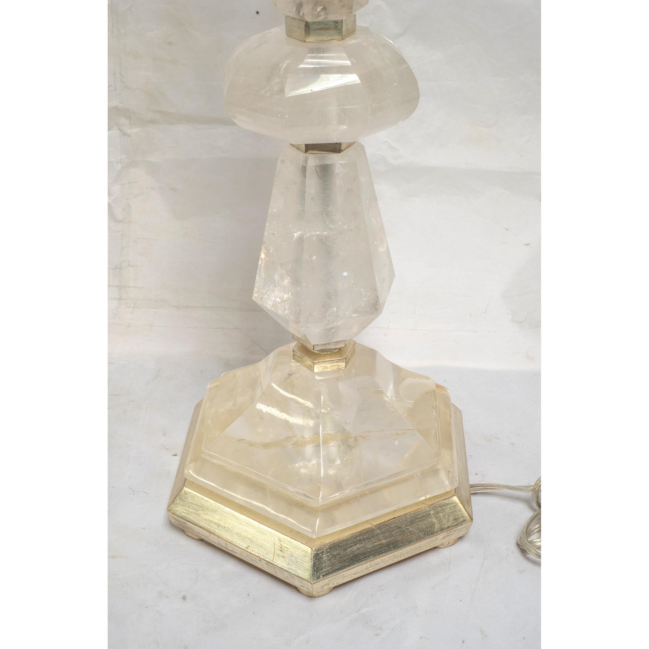 A fine pair of rock crystal candlestick form table lamps. 

Origin: French
Date: 20th century
Dimension: 33 in x 7 1/2 in x 8 3/4 in.