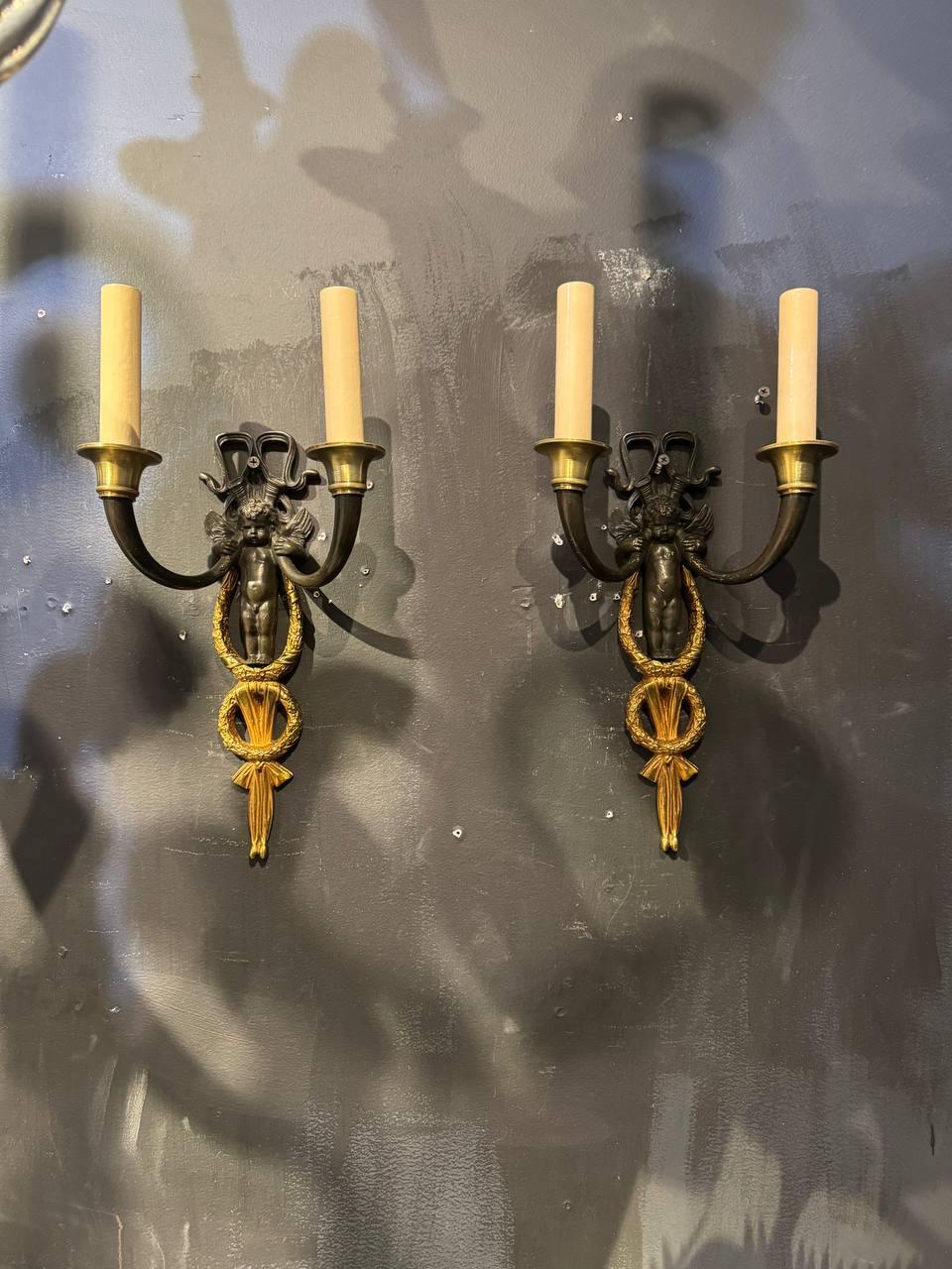 Pair of late 19th Century  French Empire sconces with cherubs body, two lights. originally for candles, newly rewired for US 