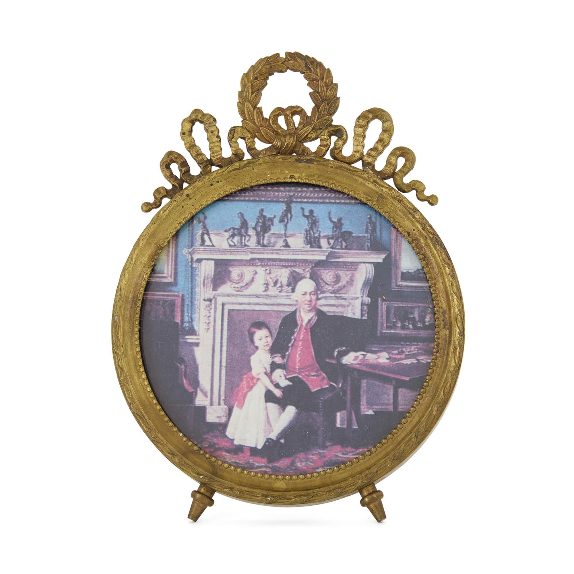 Pair of late 19th century French Empire style picture frames
French, Late 19th century
Height 16cm, width 11.5cm, depth 2/ 7 cm

Circular in shape and mounted in an easel style, this pair of small, late 19th century frames has been crafted from gilt