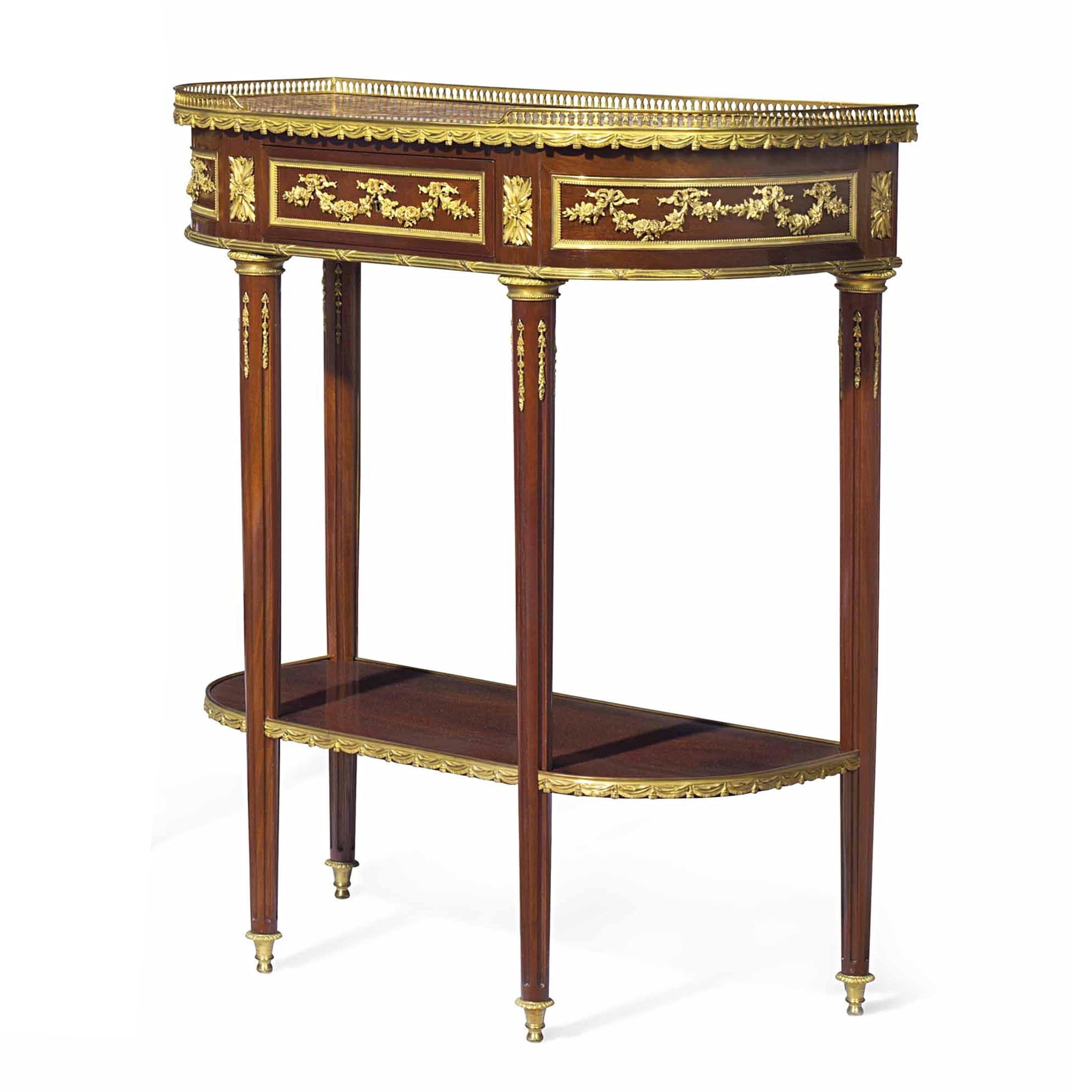 The galleried inset marble tops above swag mounts and a central festooned frieze drawer above tapering fluted legs and a medial shelf.

Date: Late 19th century
Origin: French
Dimension: 36 x 30 1/2 x 15 in.
