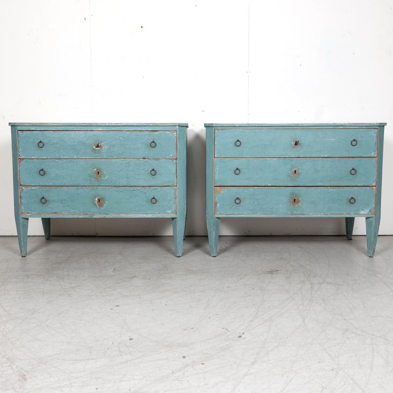 A pair of late 19th century French Louis XVI style aqua or teal painted three-drawer commodes from Provence, circa 1880s, having a rectangular plank top sitting above three full size drawers adorned with circular iron pulls. Raised on short tapered