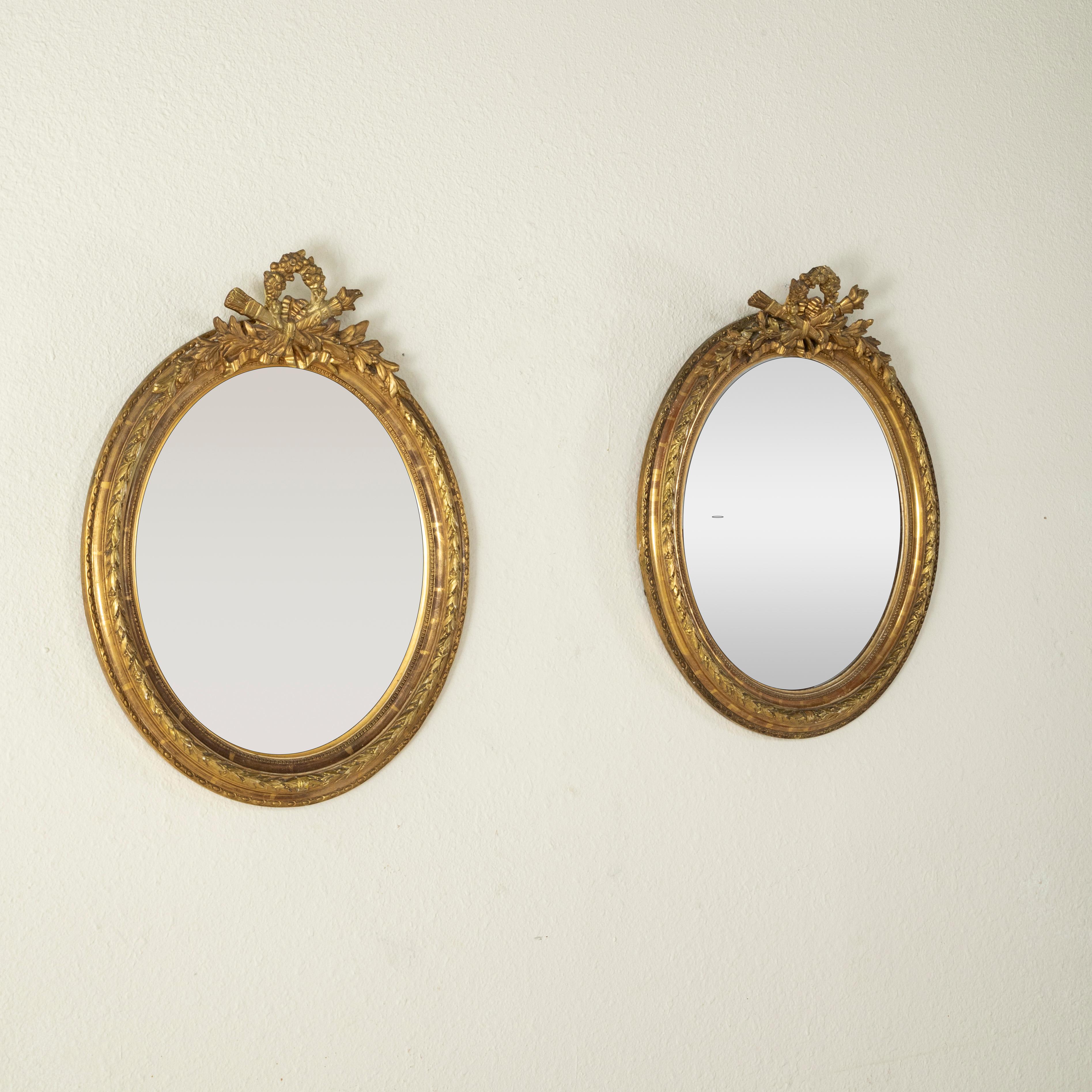 Giltwood Pair of Late 19th Century French Louis XVI Style Oval Gilt Wood Mirrors 