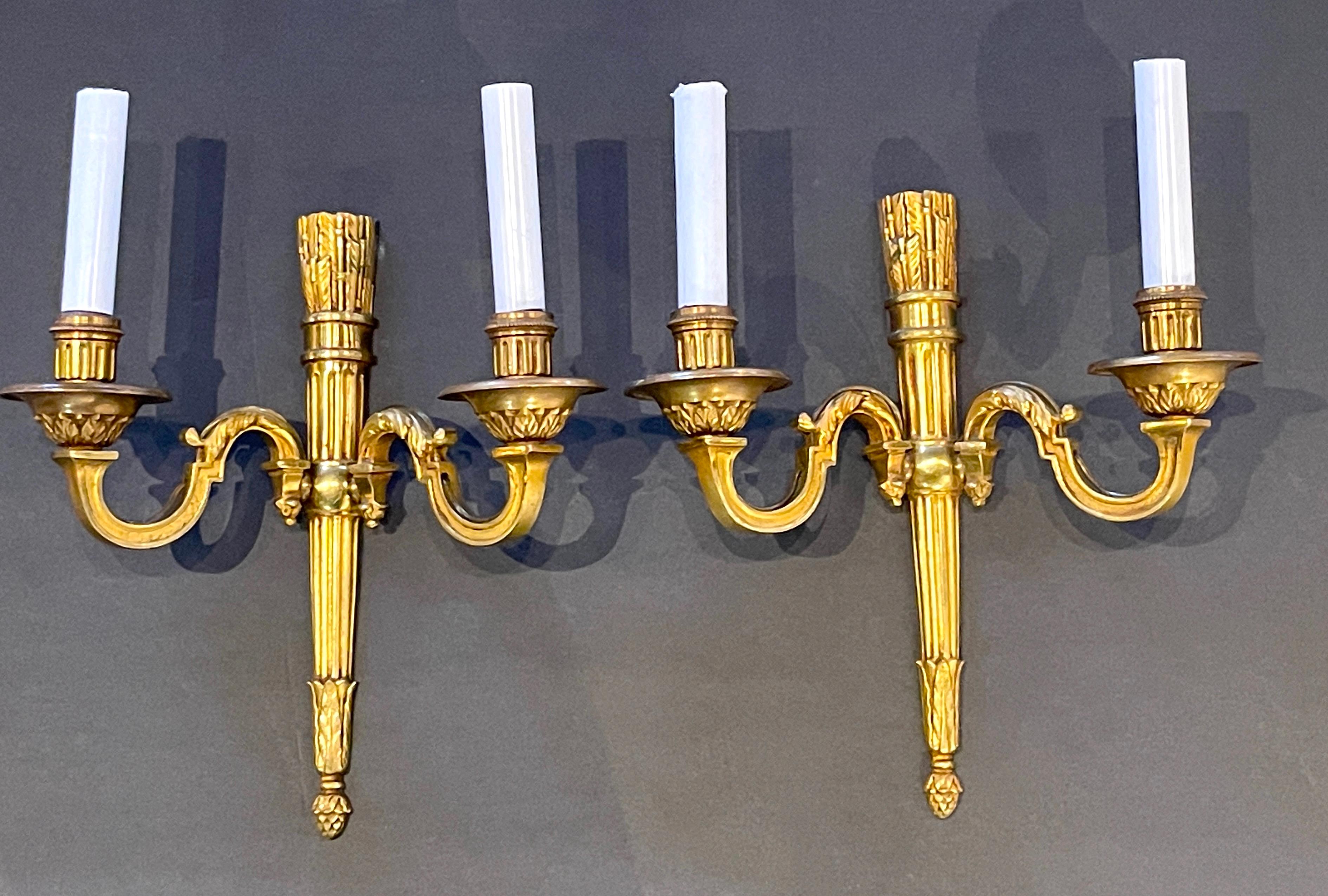 Pair of late 19th century French Ormolu Neoclassical- Regence Stye sconces.
Paris Foundry, circa 1880-1899

A beautiful, well proportioned finely cast pair of ormolu sconces in the Neoclassical style. The quiver and arrow backplate, supports the
