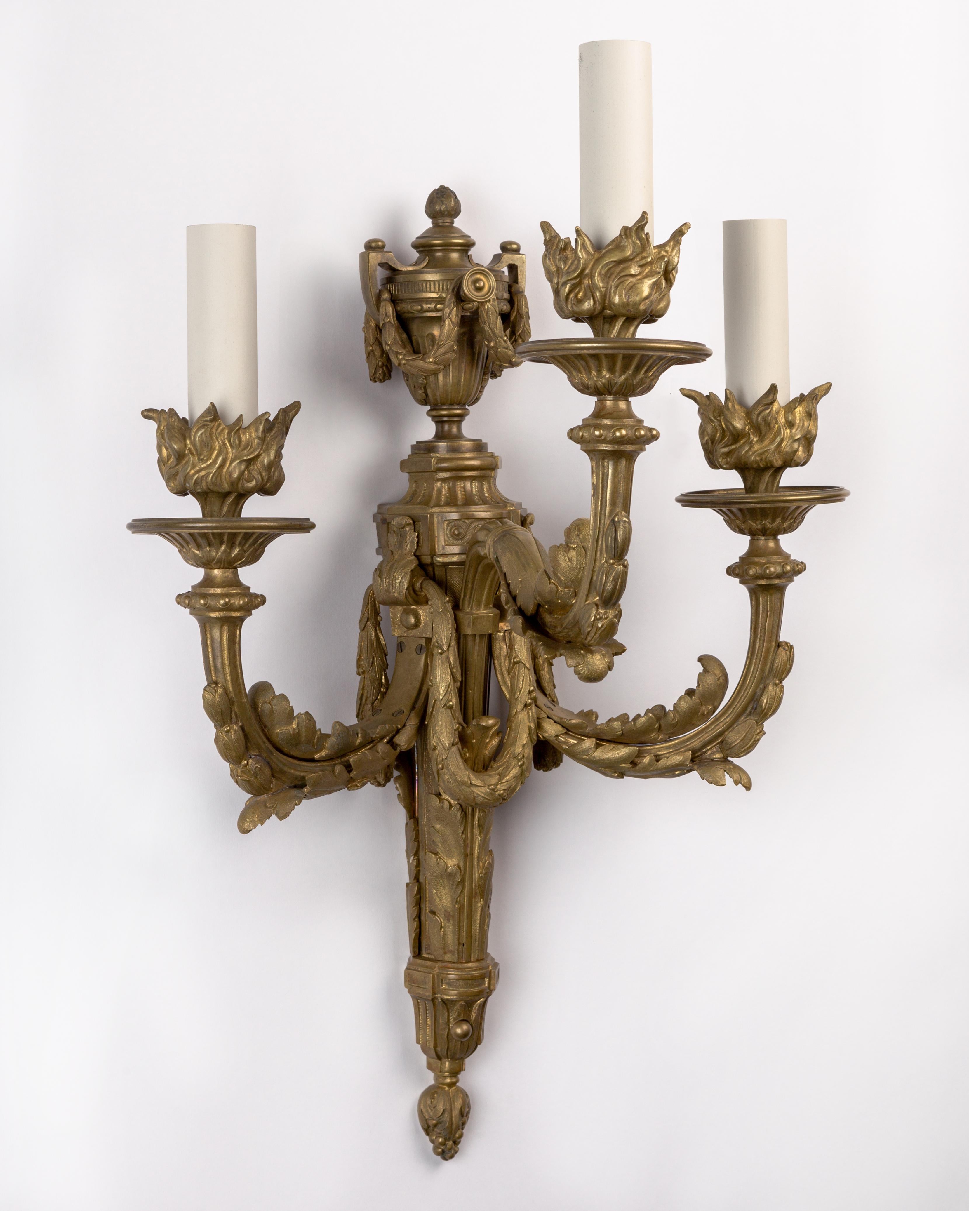 AIS1009

A pair of finely chased and strongly proportioned three-light sconces in bronze with faint traces of the original gilding, circa 1890.

Dimensions:
Overall: 25