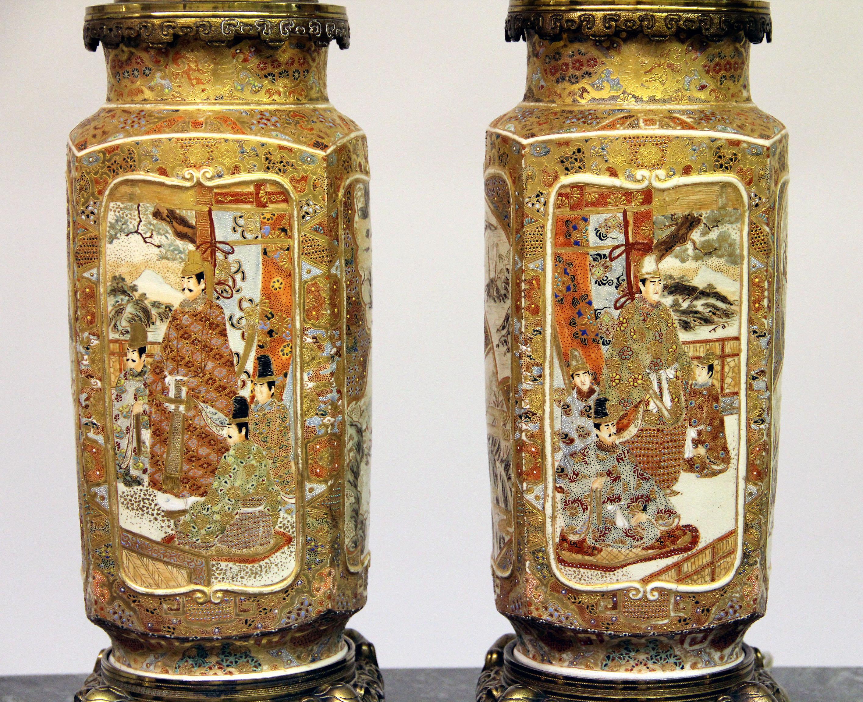 A beautiful pair of late 19th century gilt bronze and Japanese Satsuma porcelain lamps

Each side with painted panels, the front and back depicting samurai warriors, the sides with landscape scenes, surrounded by very fine raised gold designs and