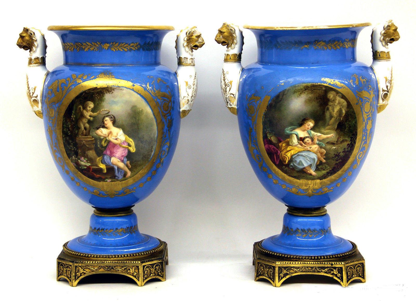 A pair of late 19th century gilt bronze and sky blue Sèvres style porcelain vases.

The front of the vases painted with a woman and cherubs, the back as landscape scenes. The handles depicting a lion.

In late 1739 - early 1740 the Sèvres