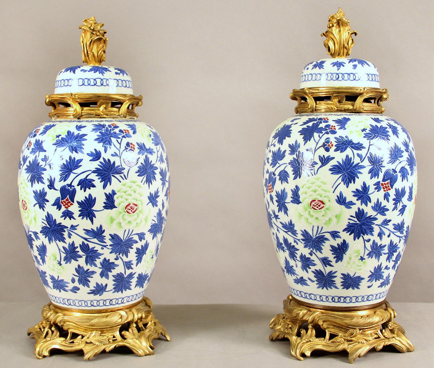 A wonderful pair of late 19th century gilt bronze mounted continental vases in Chinese Style

The vases painted with floral designs in beautiful blue, green and red colors, sitting on a gilt bronze base.
 