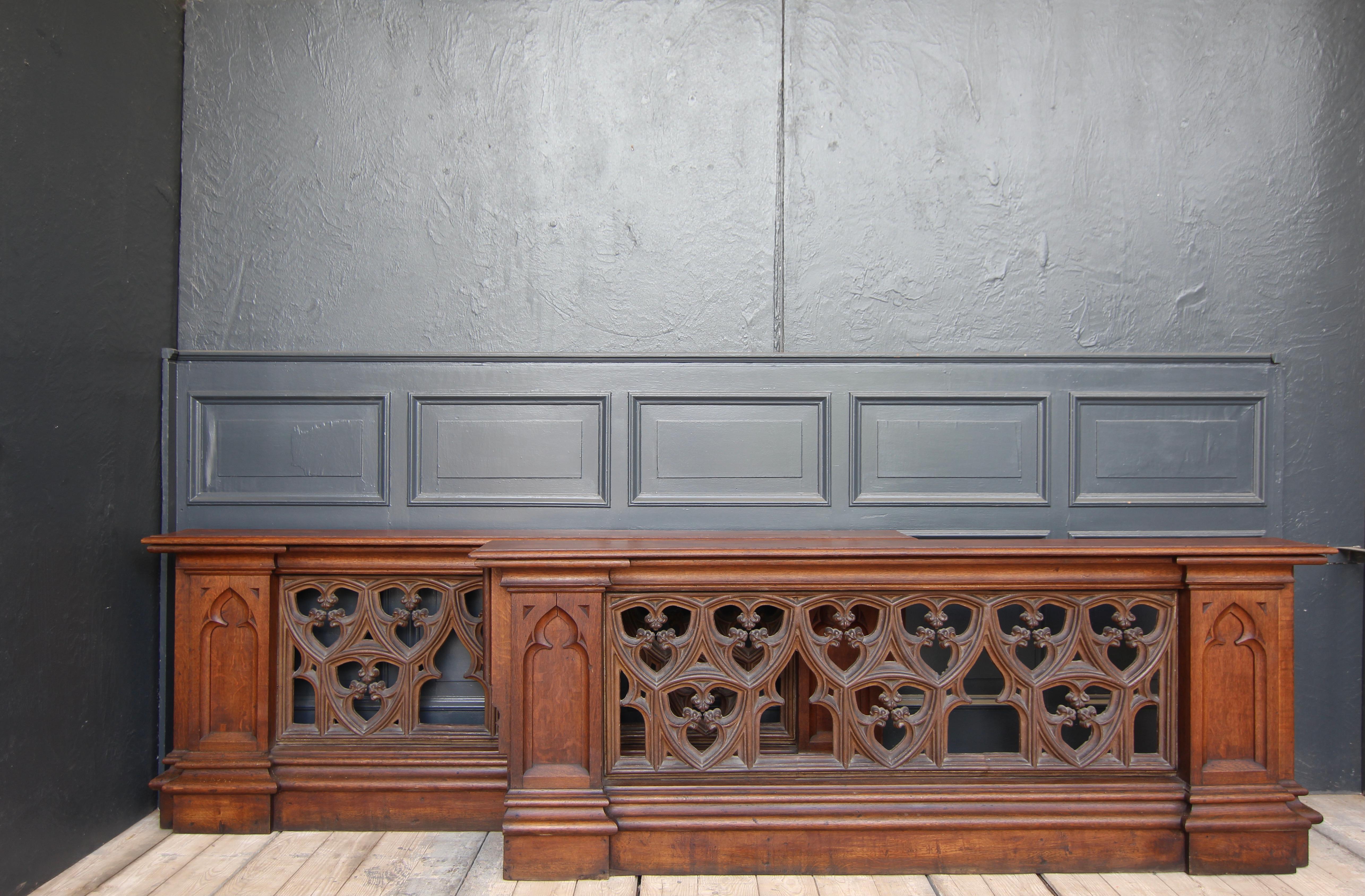 Neo-Gothic choir screens resp. 2 balustrades from the late 19th century. Solidly made of oak wood and cast iron.

Choir screens have been part of the interior decoration of churches since early Christian times. Today, as then, they separate the