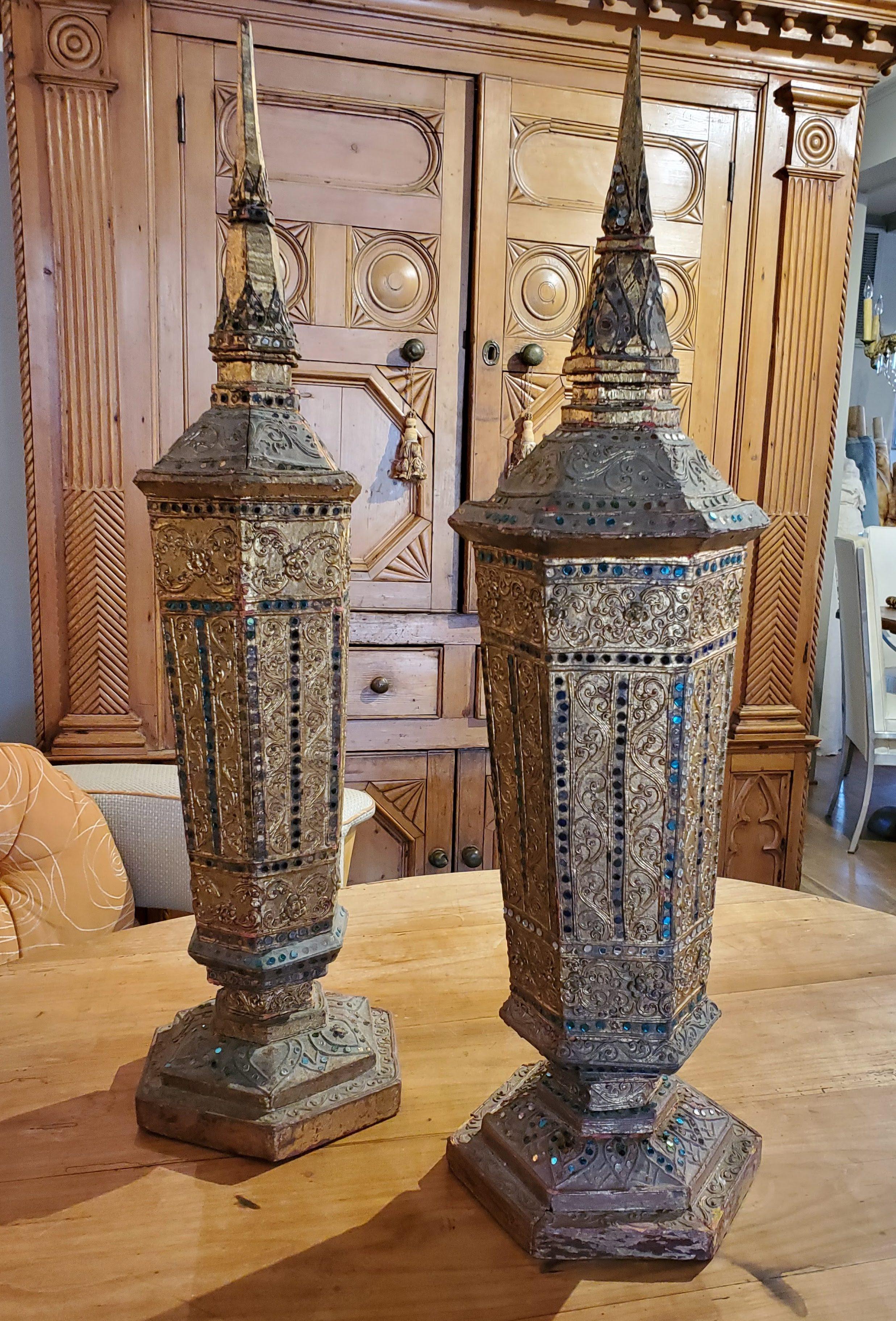 This pair of late 19th century decorative urns are not only beautiful they are totally unique. Hexagonal forms in golden gilt, inlaid with tiny colored mirrors, make these urns special. Each urn features it's own intricate design but from afar look