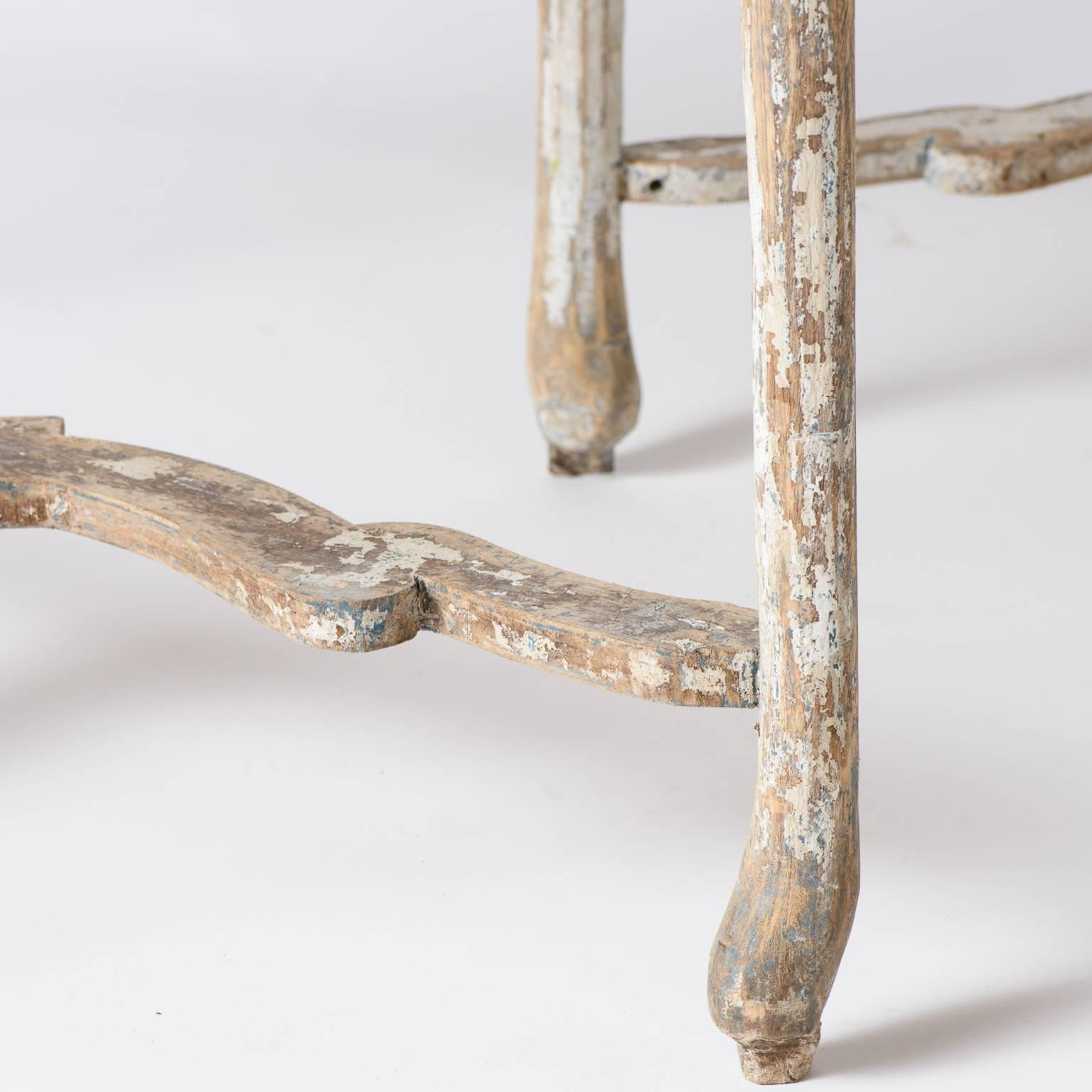 These demilune tables have the beautiful well-worn look only found on treasured pieces of furniture handed down over time. They have great form with curved legs and unique stretchers showing traces of old white paint. The scrubbed tops have a lovely