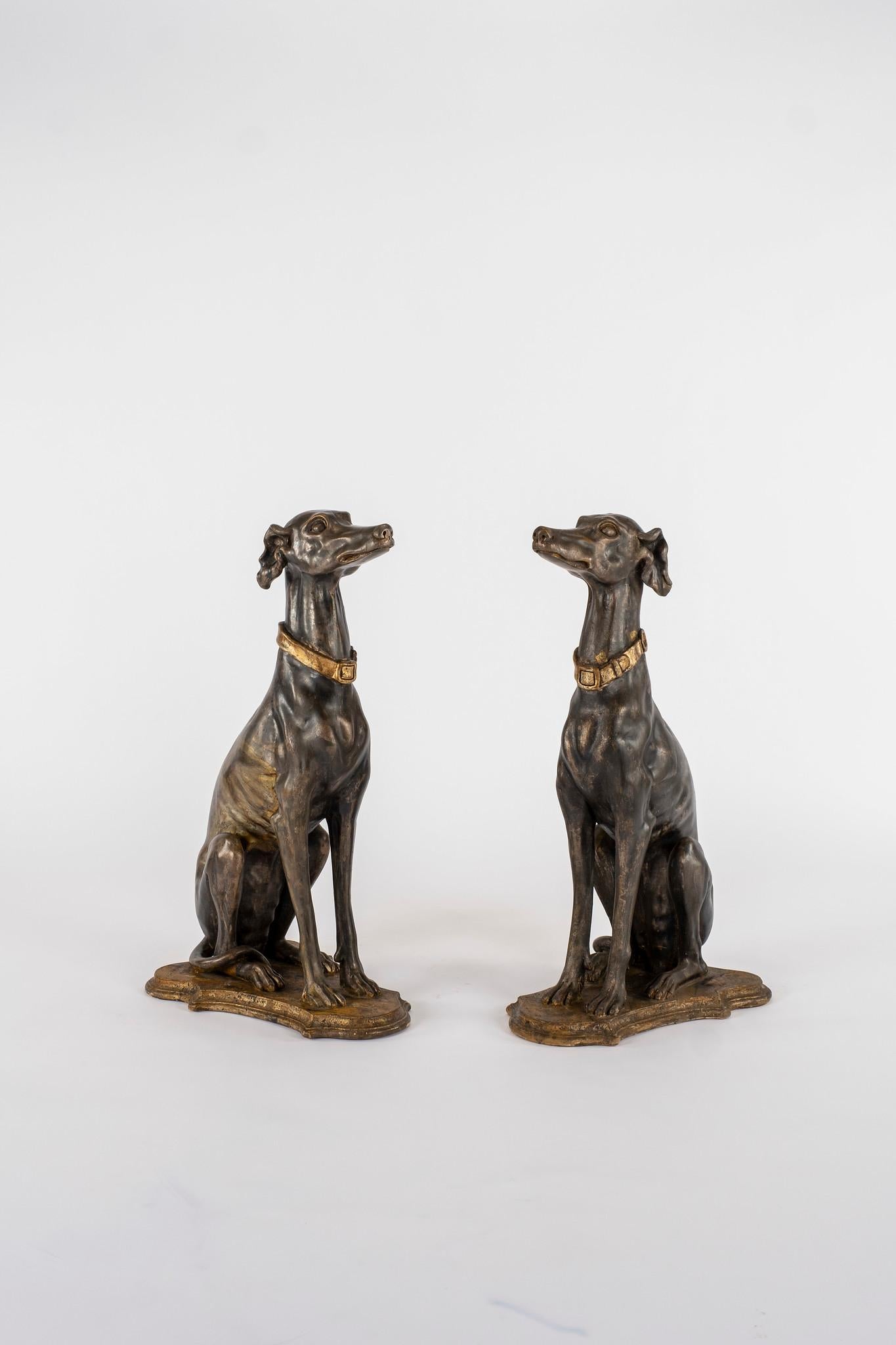 This pair of tall Italian greyhound sculptures are from the late 19th century. Silver gilding with patination, skillful attention has been brought to the details to include their head, ears, body and paws, around which their tail is wrapped, as well