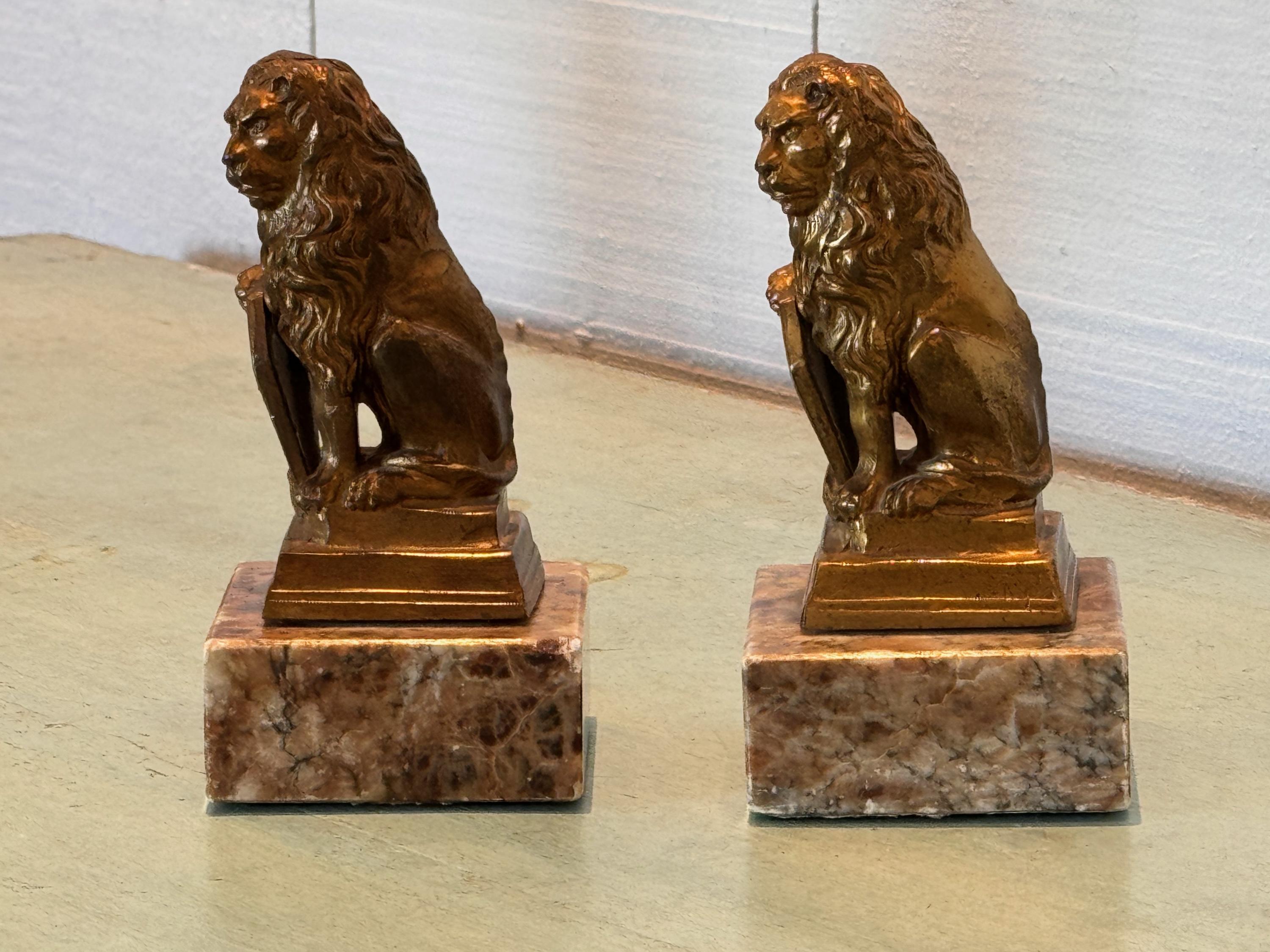 A cute pair of metal lions mounted on marble bases. Here them roar.