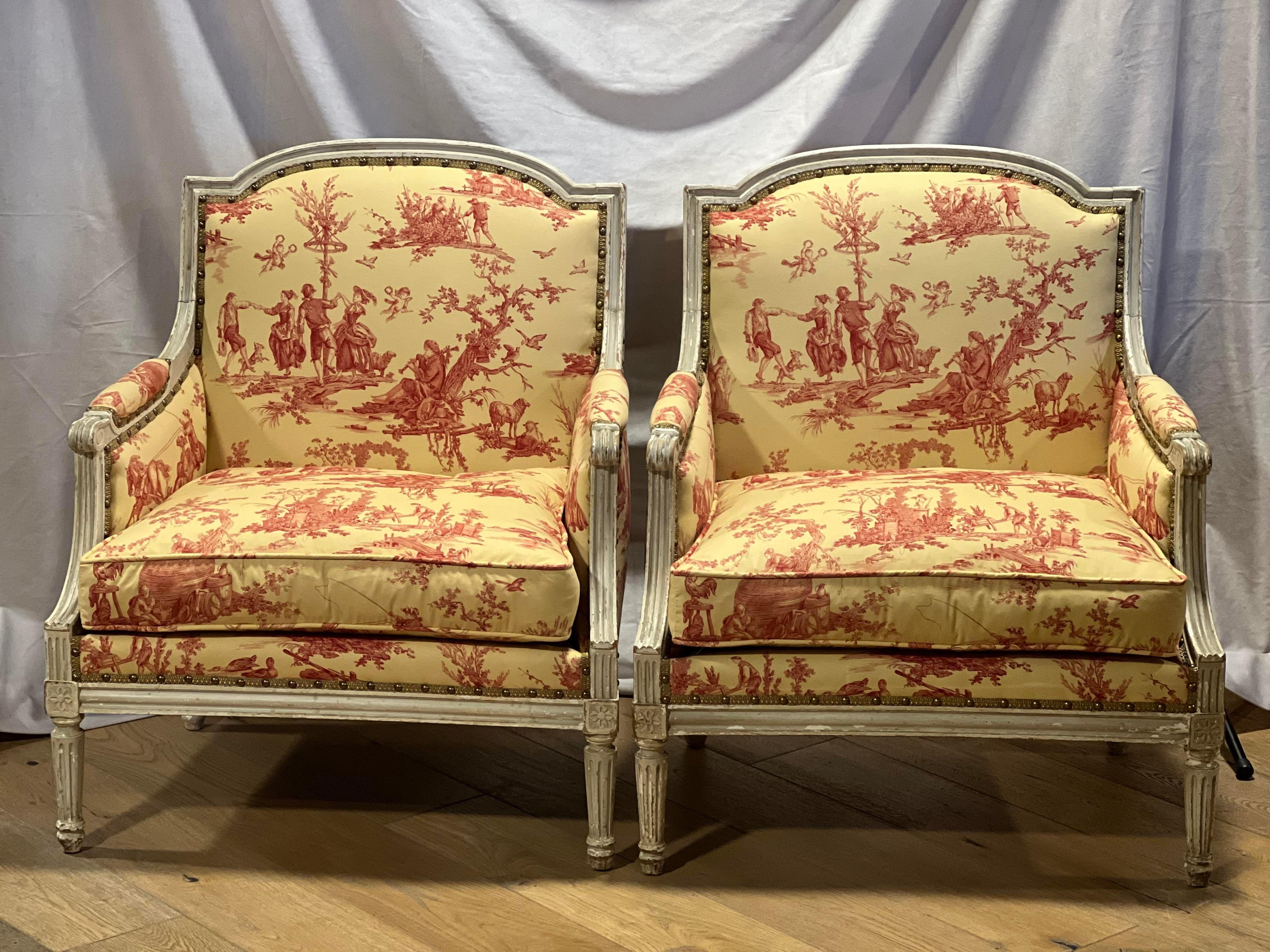 Pair of Late 19th Century  Louis XVI Style French Marquise Chairs.  Original white lacquer paint.  The chairs have new filler as well as a new fabric.