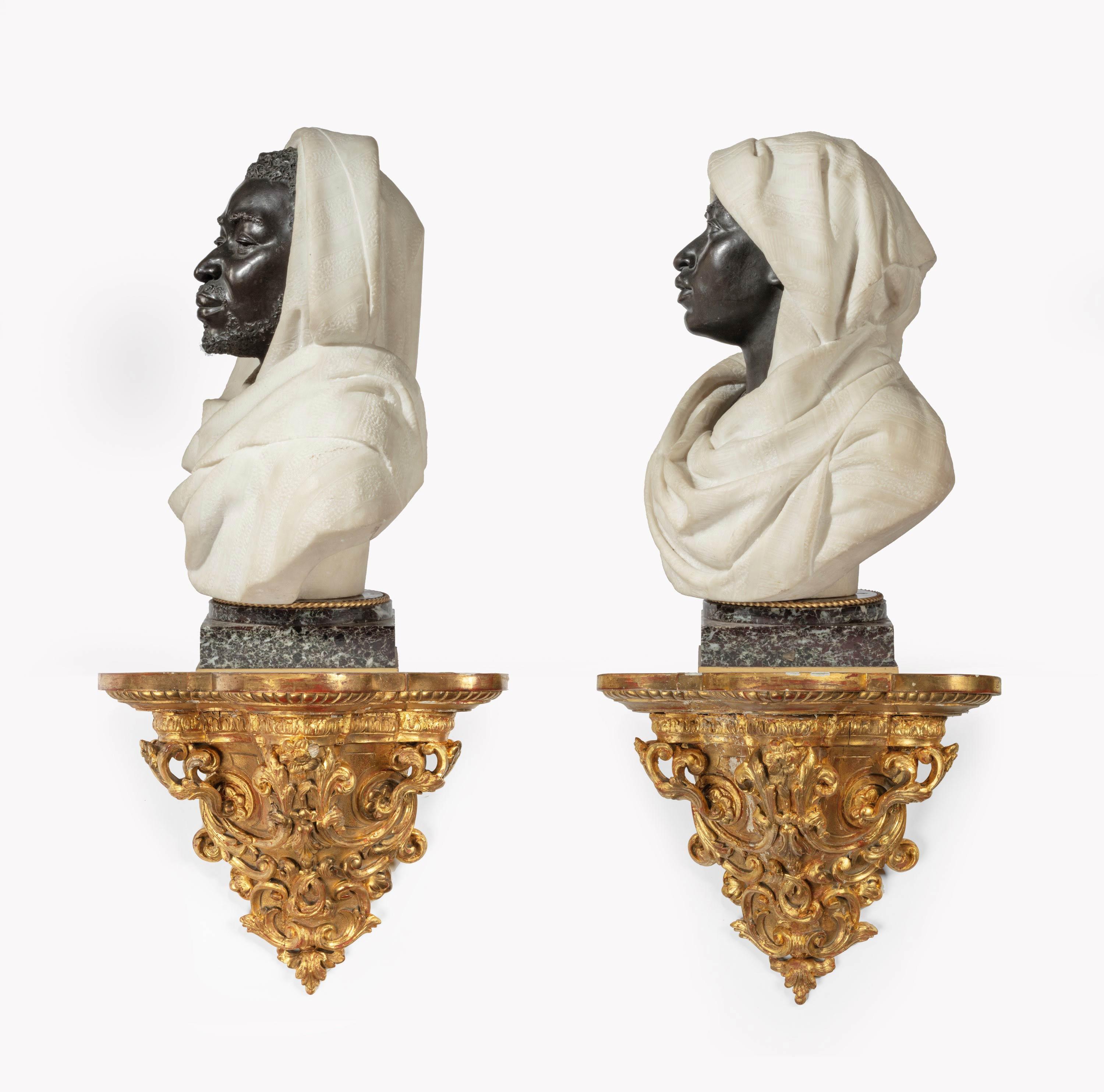 Charles Caccia and Henry Dasson respectively 1883 and 1885. A quite exceptional pair of Carrara marble and bronze figures of Nubian male and female figures. Both signed, the bases and socle by Dasson. From the distinguished collection of Sir Ralph
