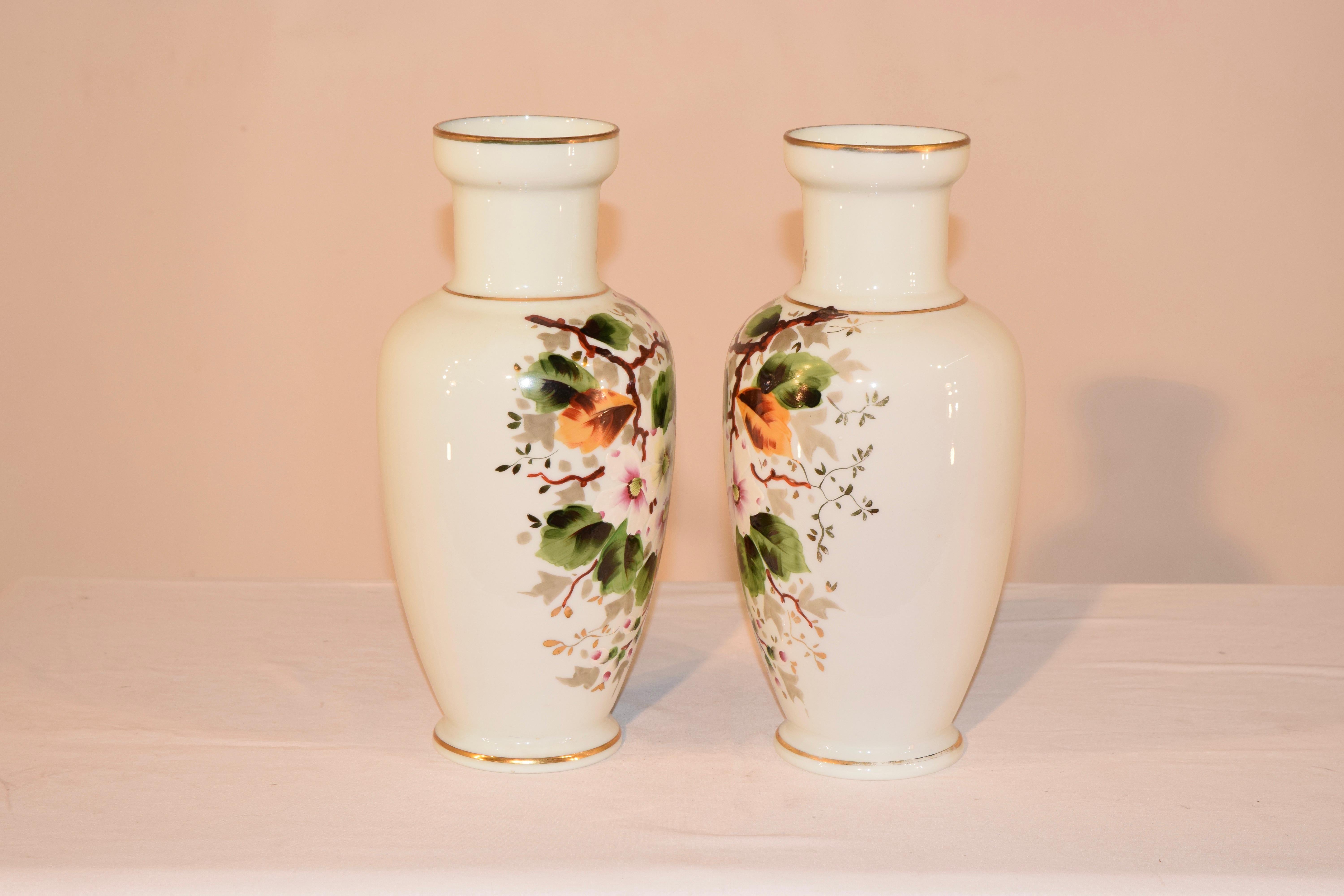 Pair of late 19th century Opaline glass vases from France. they are wonderfully shaped and have lovely floral and vine hand painted decoration.