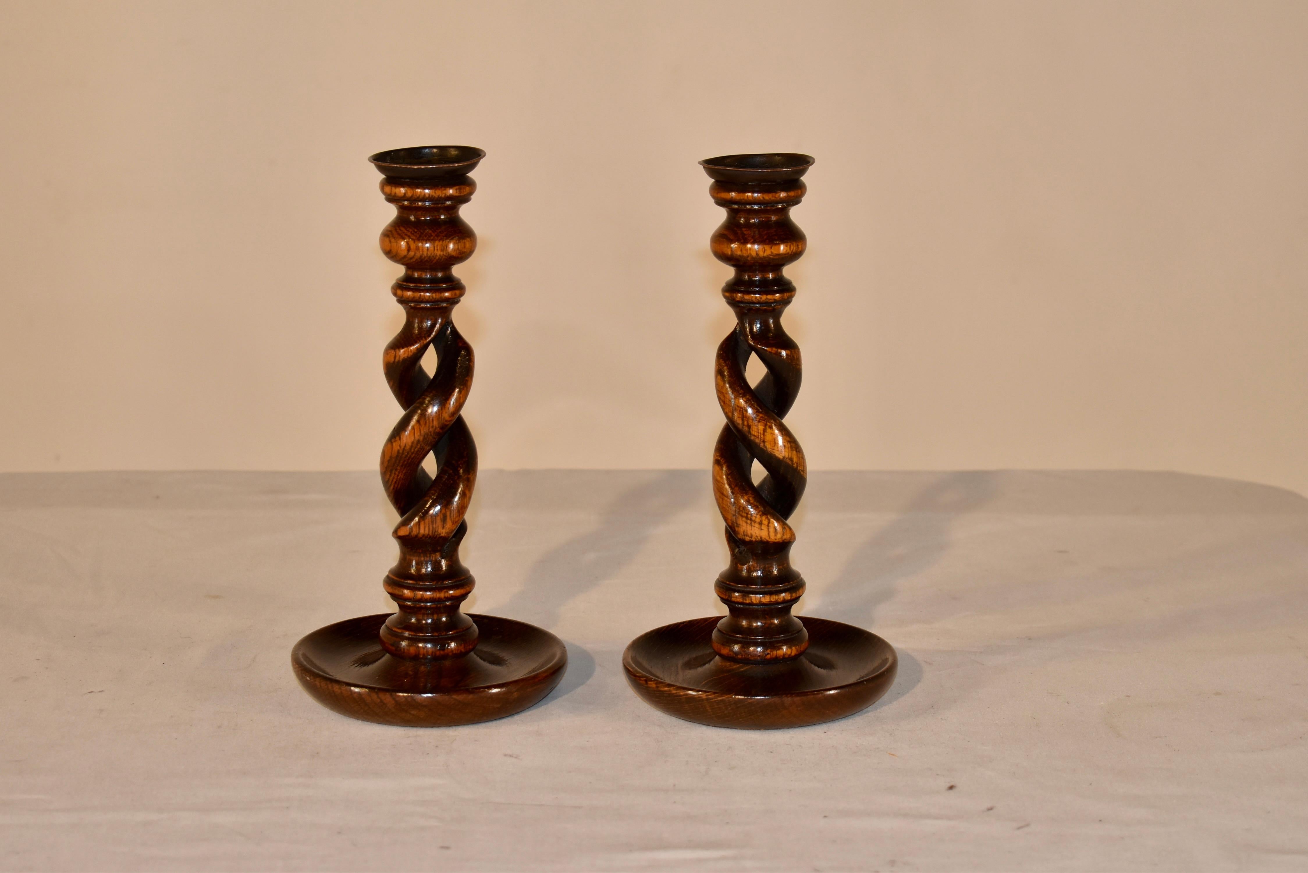 Pair of late 19th century open barley twist candlesticks that have wonderful hand turnings. There are hand cast brass candle cups and lovely hand turnings and open twist stems, supported on hand turned dish shaped bases.