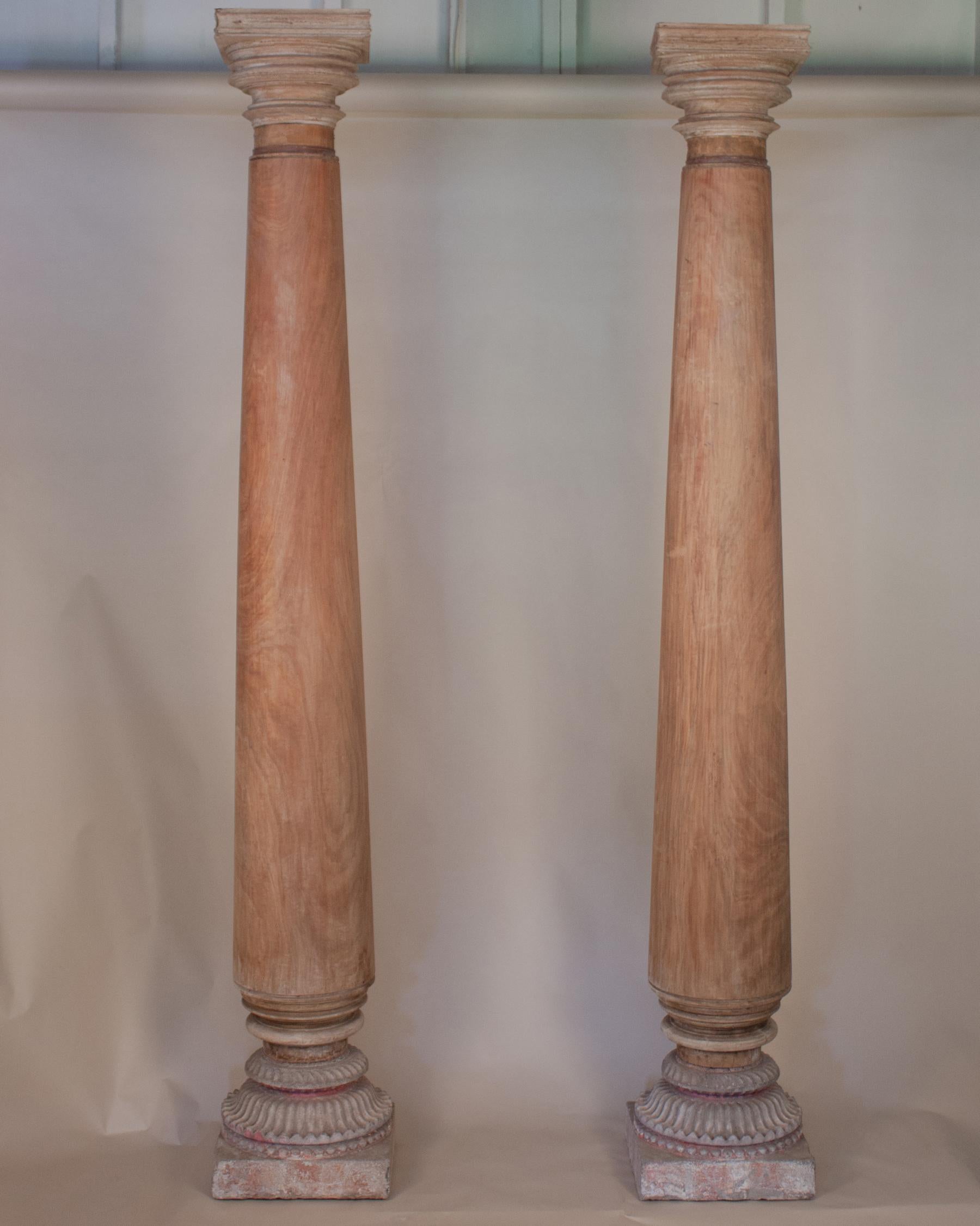 An impressive pair of late 19th century satinwood columns/pillars and capitals with stone bases from Portuguese Goa. The matte satinwood has a beautiful tone and grain, and the bases have retained traces of their original paint.
Overall Height: