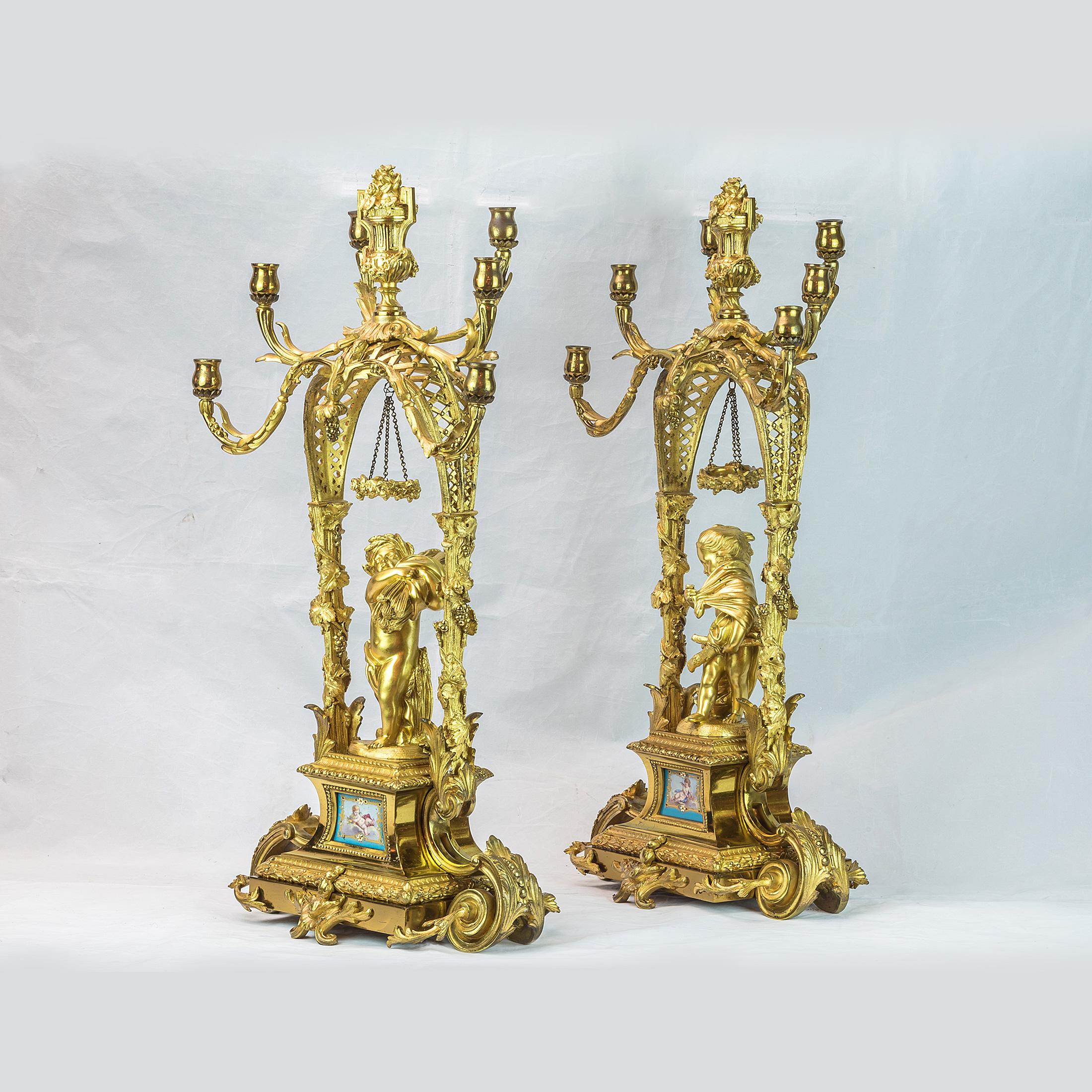 Fine pair of unusual six-light gilt bronze candelabras depicting a boy and a girl. The girl gathering wood; the boy carrying a bundle of wheat. 

Origin: French
Date: circa 1880
Dimension: 22.5 in. x 11.75 in. x 6.75 in.