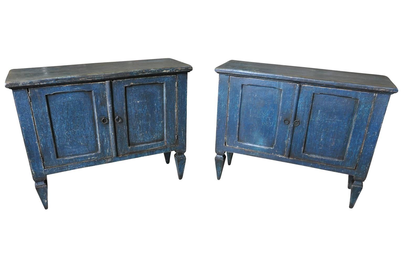 A terrific pair of later 19th century two-door buffets from the Catalan region of Spain. Beautifully constructed from painted wood with two paneled doors over nicely tapered legs.