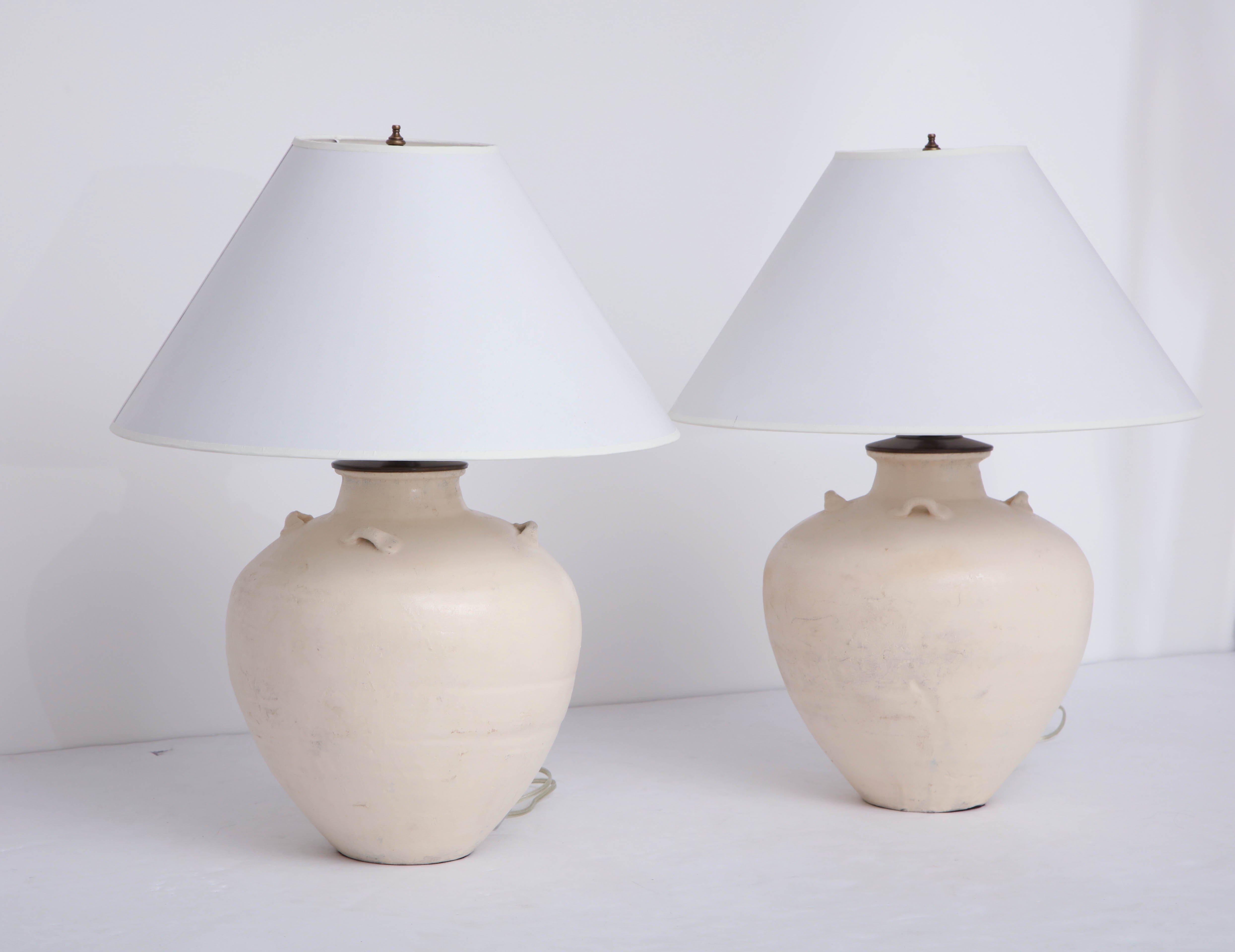 Pair of late 19th century terracotta wine vessel lamps, white glaze.