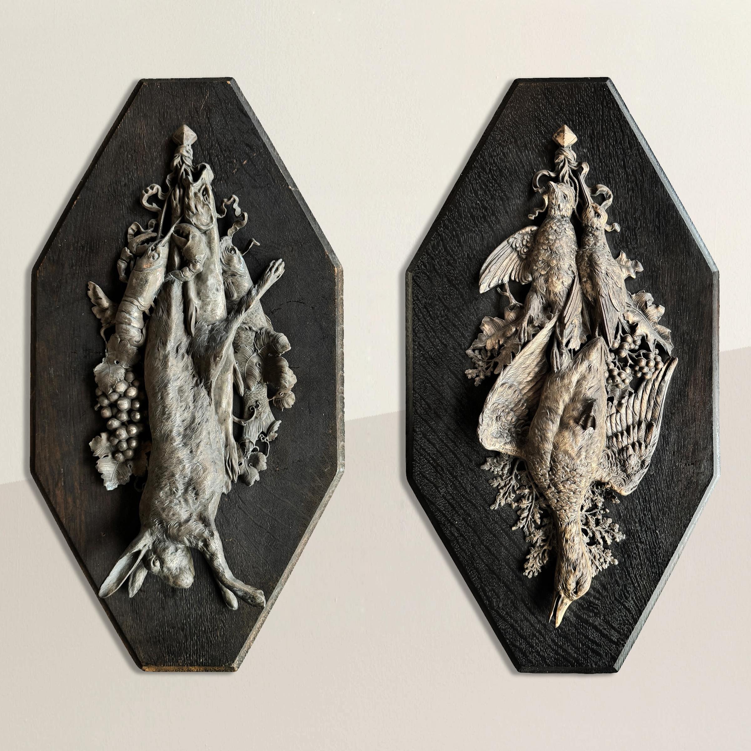 This striking pair of late 19th- to early 20th-century German hunt trophy wall plaques, masterfully cast in nickel and brass, are the work of renowned sculptor G.G. Bommer. One plaque features a richly detailed hare, surrounded by an abundant catch